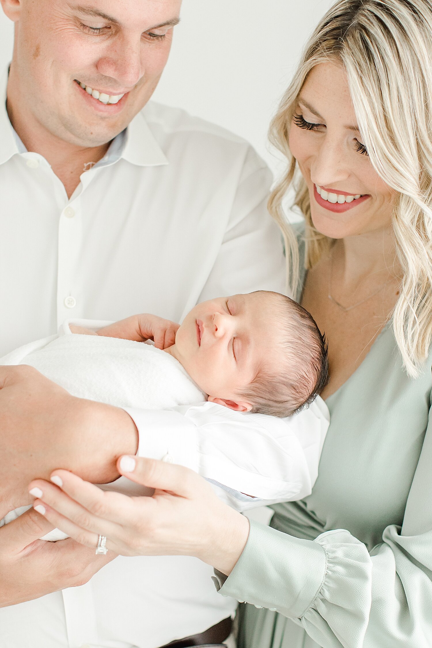 Newborn portrait with mom, dad and son. Photo by Kristin Wood Photography.