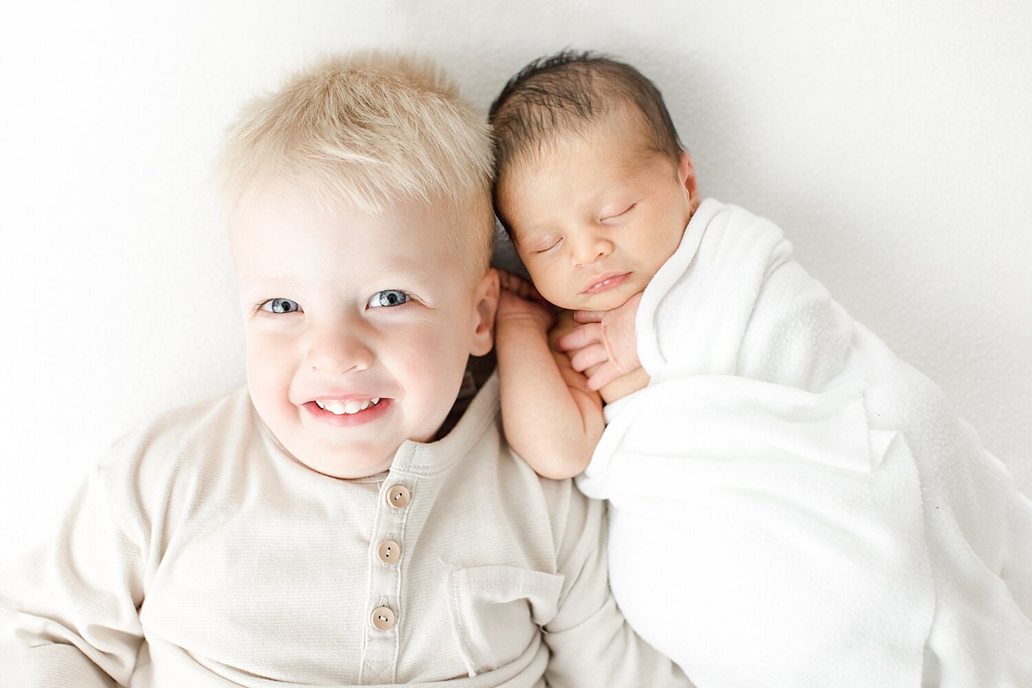 Brothers laying beside each other. Photo by Kristin Wood Photography.