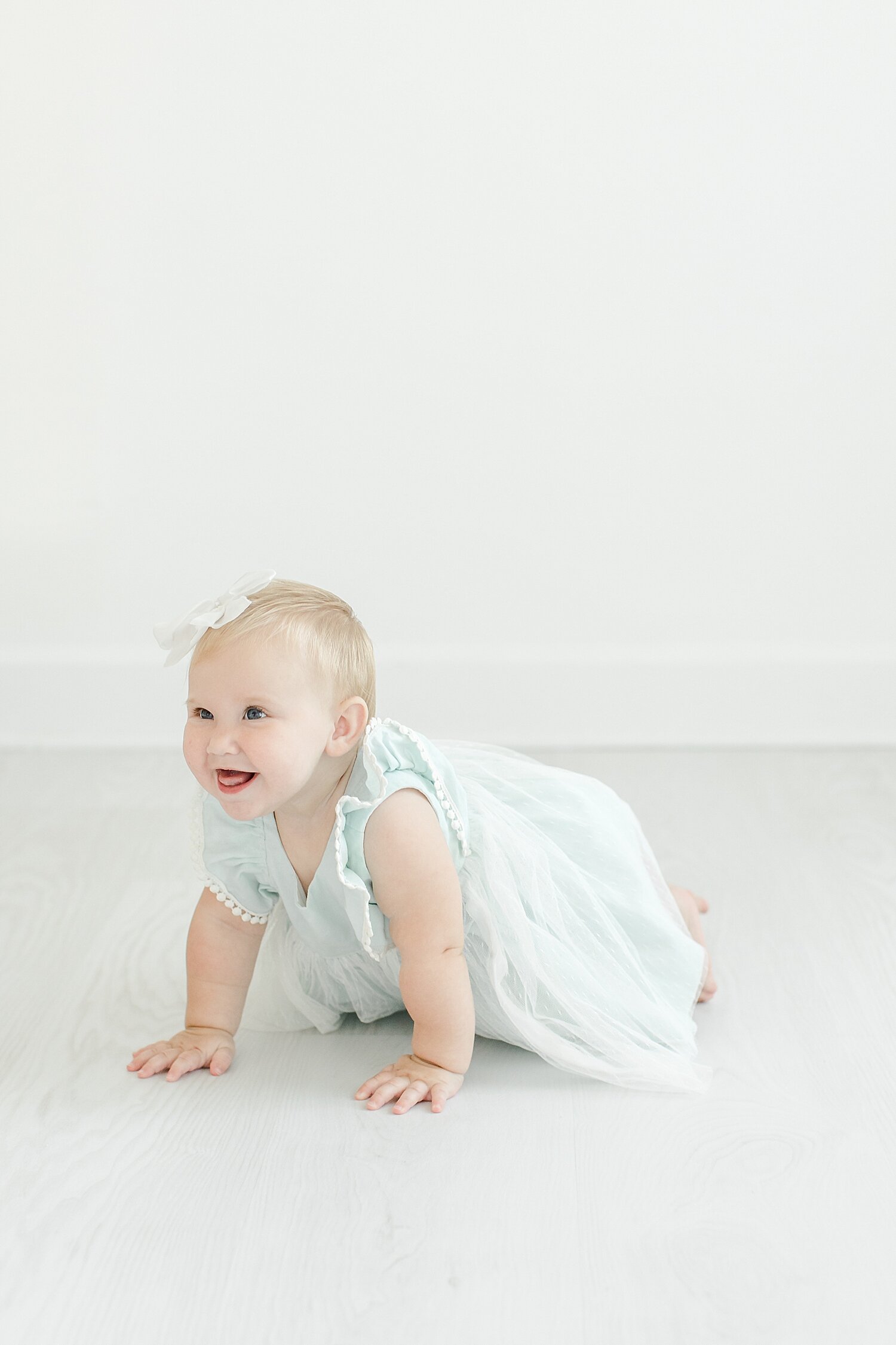 8 month old crawling for photos in studio with Kristin Wood Photography.