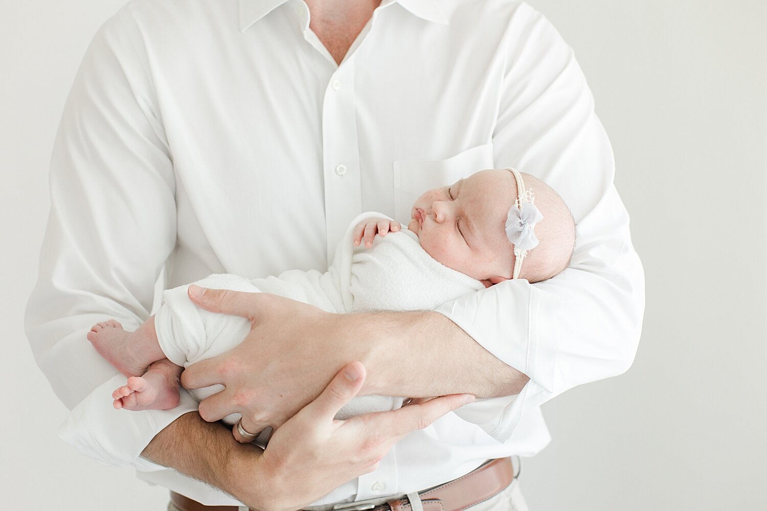 Father-daughter photos during newborn photoshoot with Kristin Wood Photography.