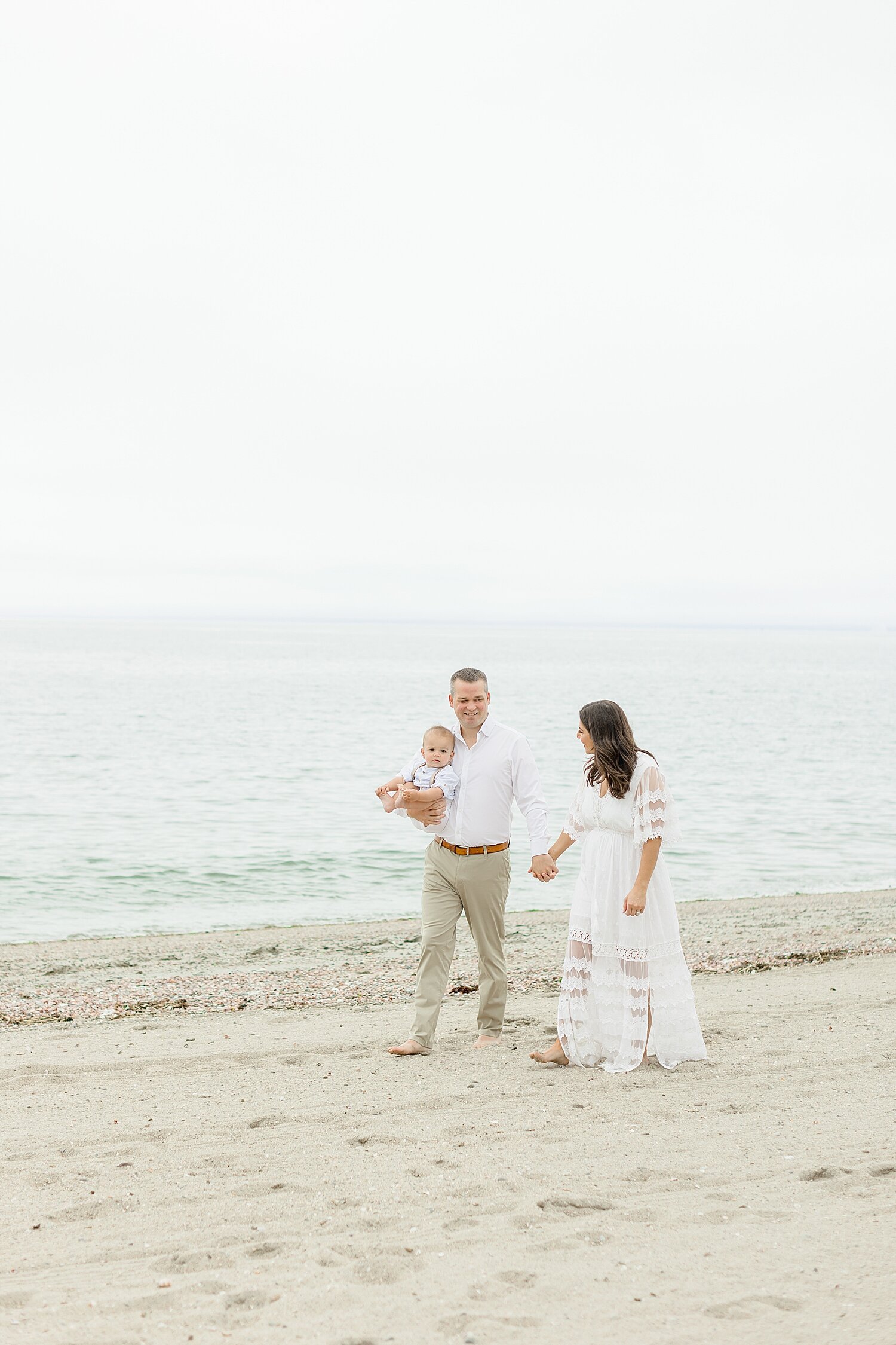 Parents walking along the beach with their son | Kristin Wood Photography