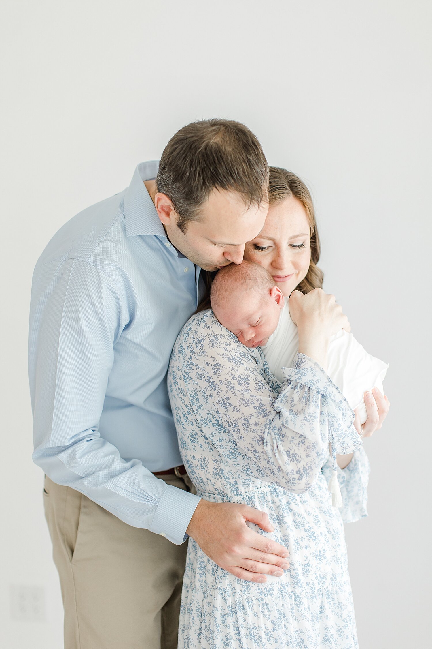 Parents snuggling their newborn son | Kristin Wood Photography