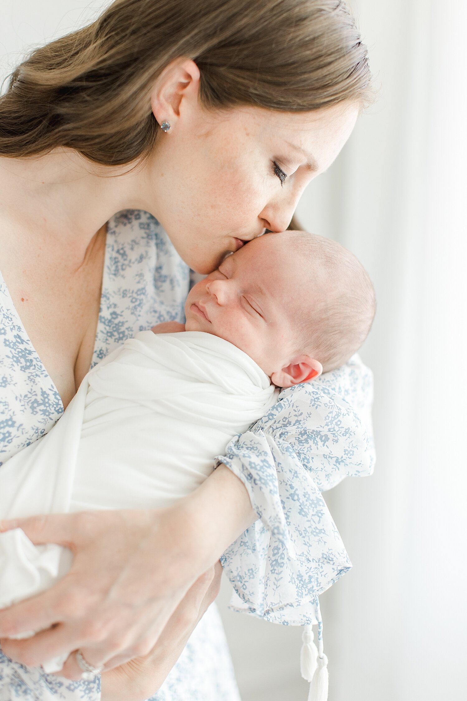 Mom holding her son for newborn photos with Kristin Wood Photography.