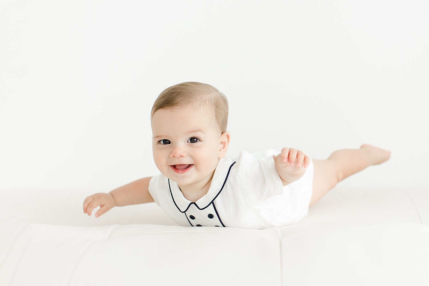 Baby doing superman pose! Photo by Kristin Wood Photography.