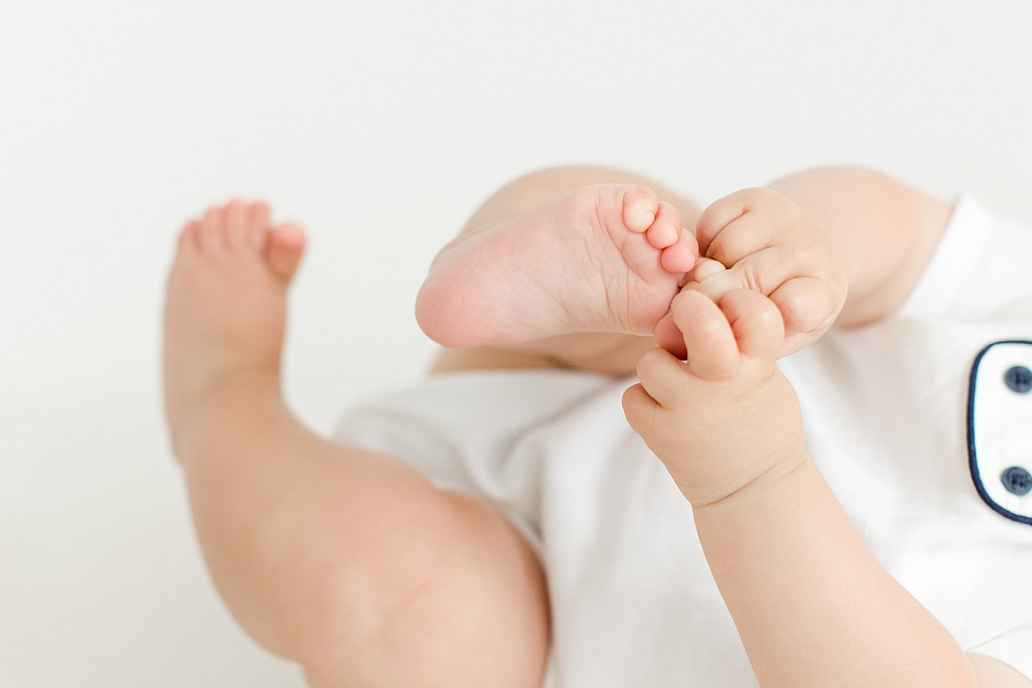 Baby playing with his toes | Kristin Wood Photography