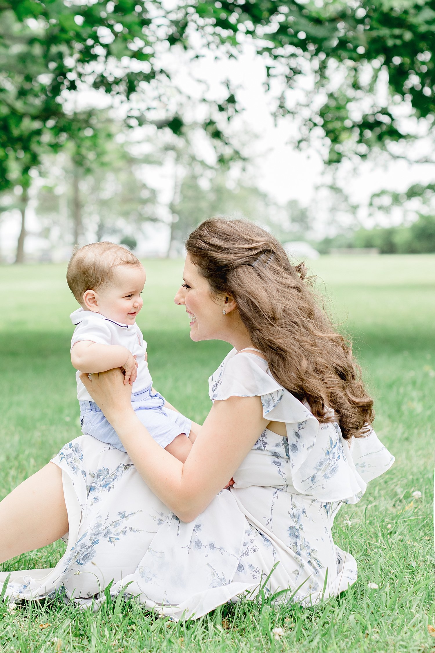 Mom sitting in field with her son | Kristin Wood Photography