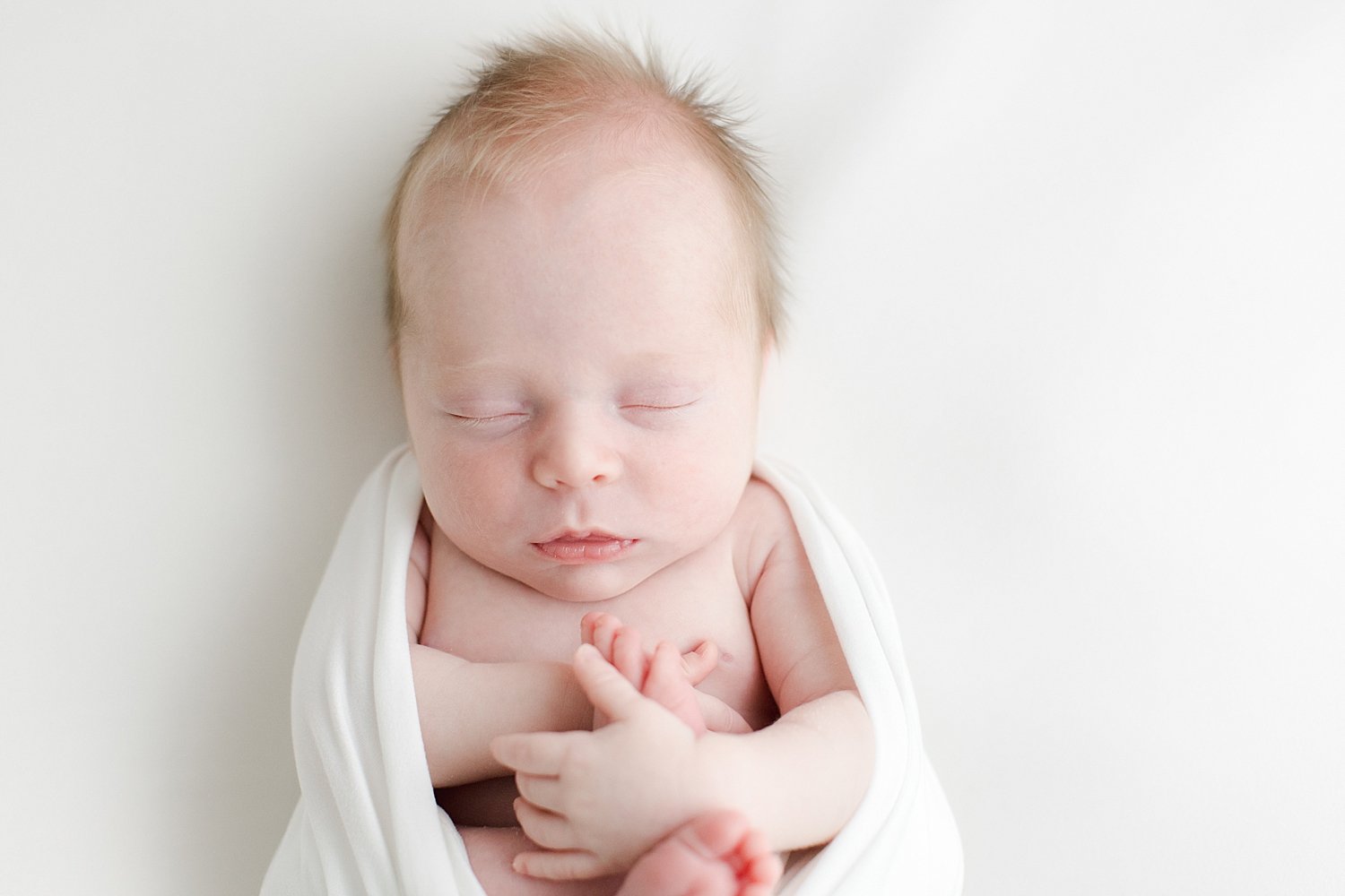 Baby swaddled on back for newborn photos | Kristin Wood Photography