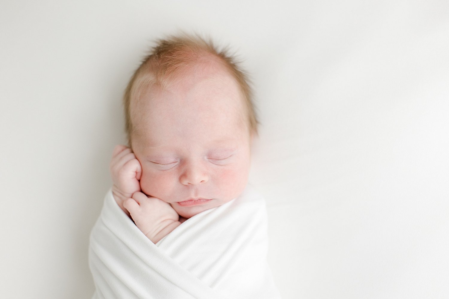 Baby swaddled on back for newborn photos | Kristin Wood Photography