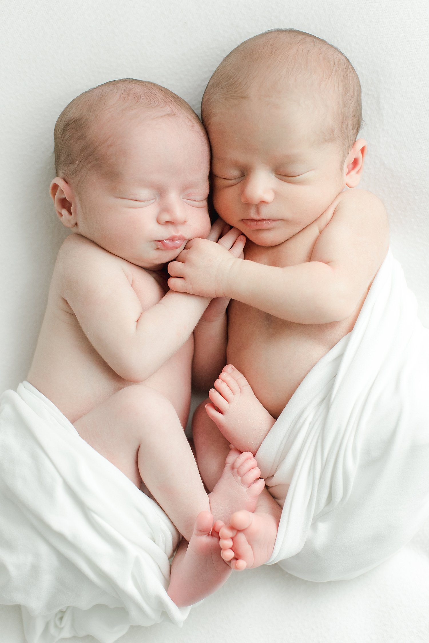Twin brothers curled up beside each other | Kristin Wood Photography