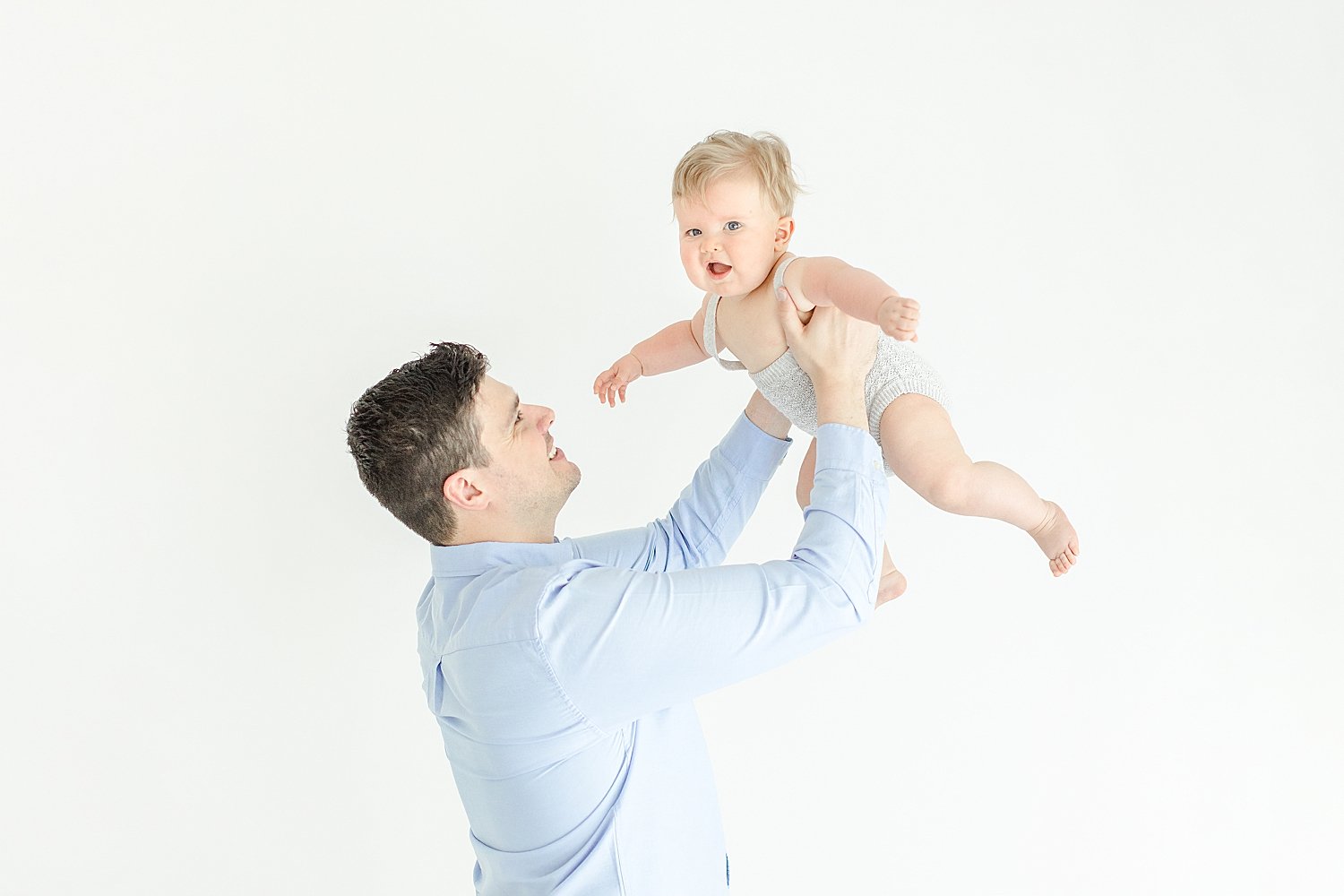 Dad playing airplane with six month old son | Kristin Wood Photography