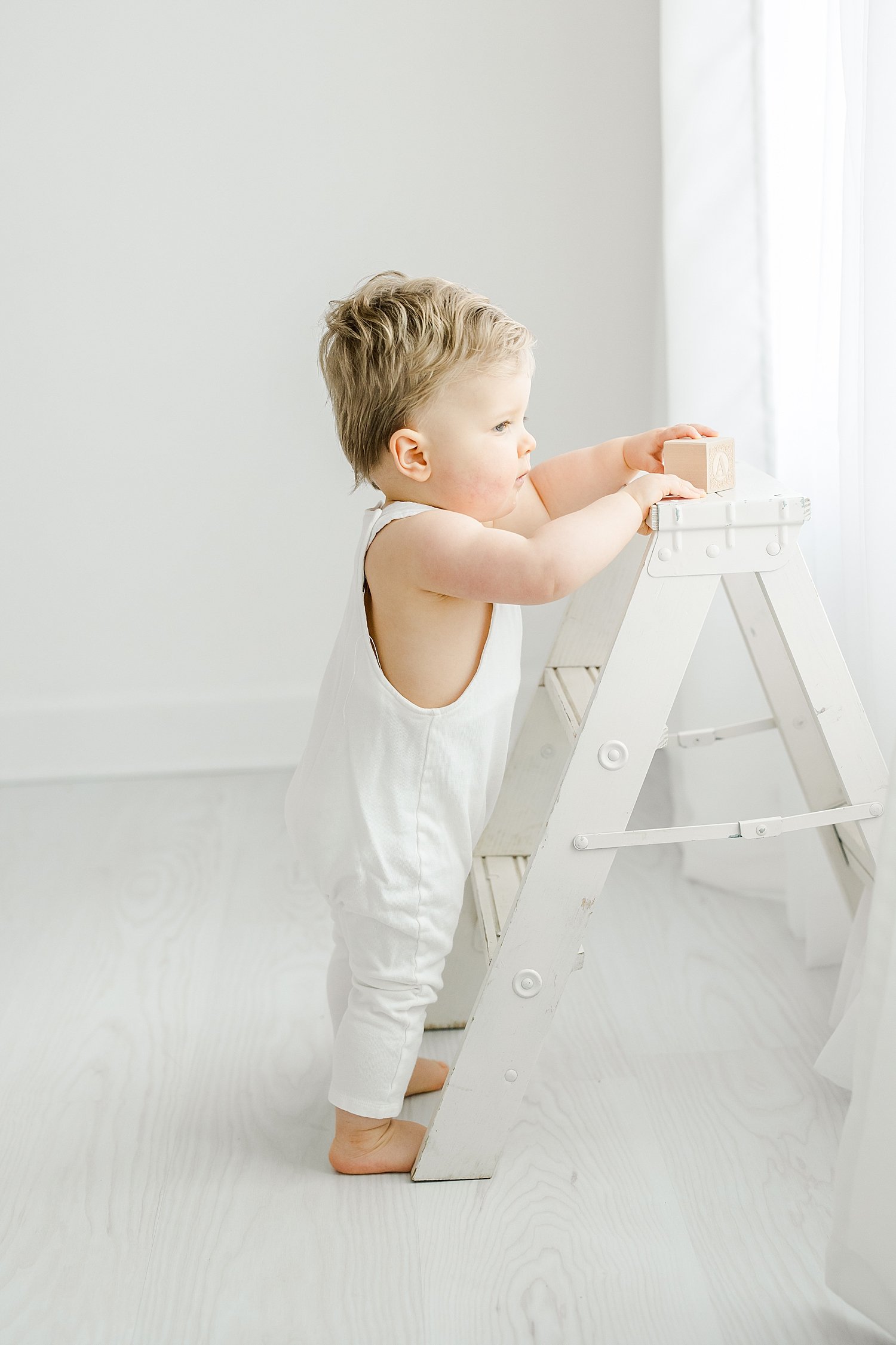 One year old standing by a ladder | Kristin Wood Photography