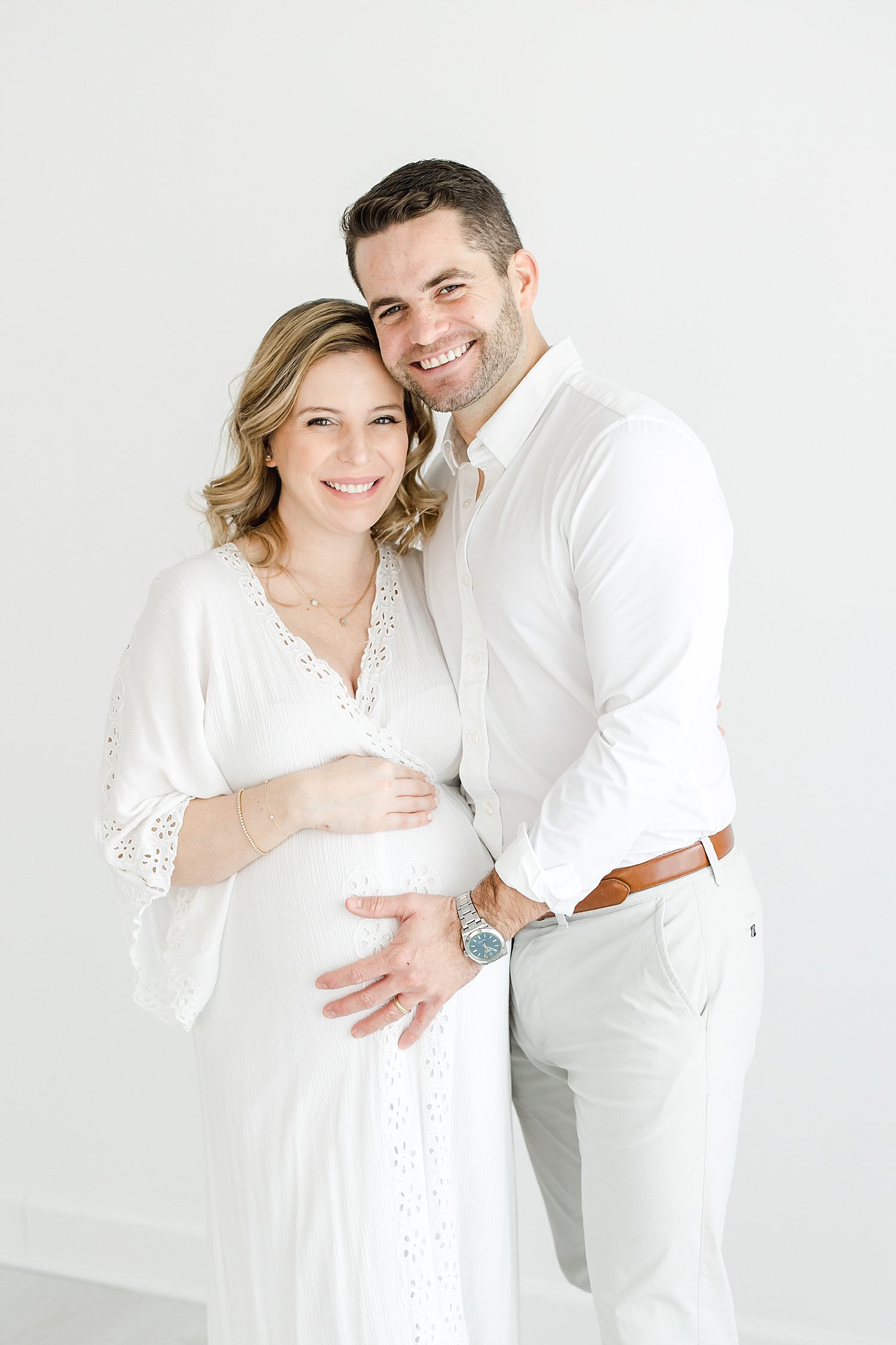 Dad with hand on Mom's pregnant belly | Kristin Wood Photography