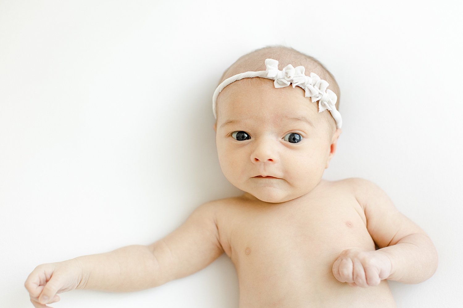 Newborn baby girl wide awake for photos with Kristin Wood Photography.
