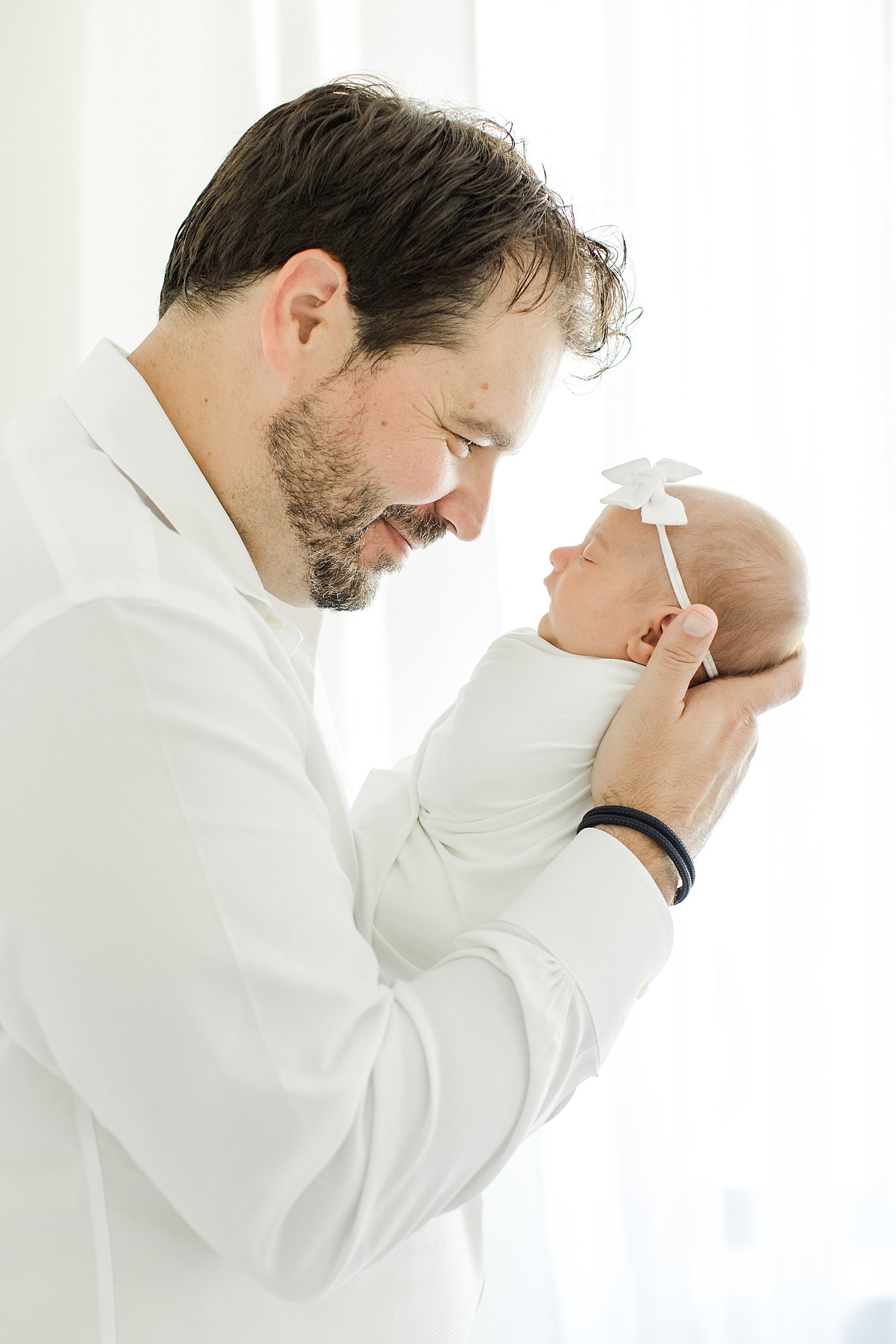 Dad holding his baby girl up close to him | Kristin Wood Photography
