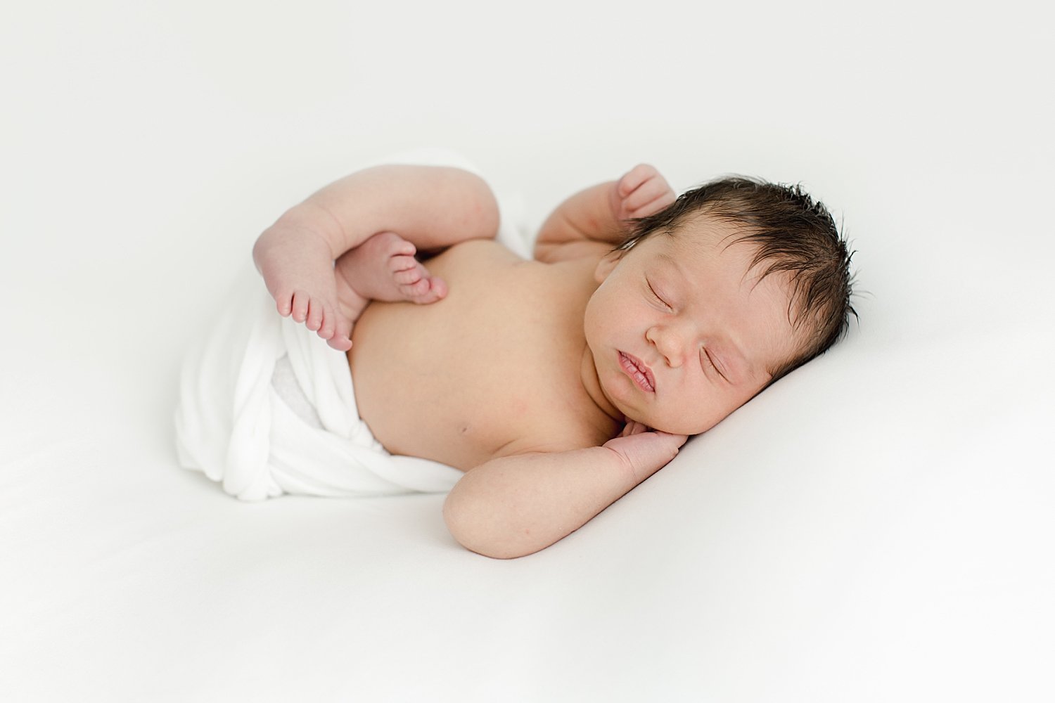 Newborn baby boy laying on his side | Kristin Wood Photography