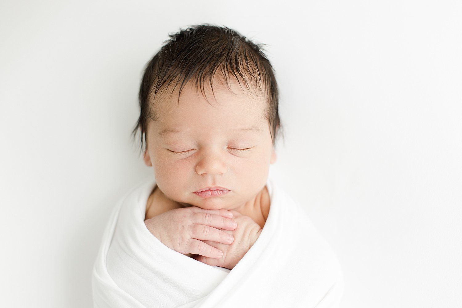Newborn baby swaddled in white | Kristin Wood Photography