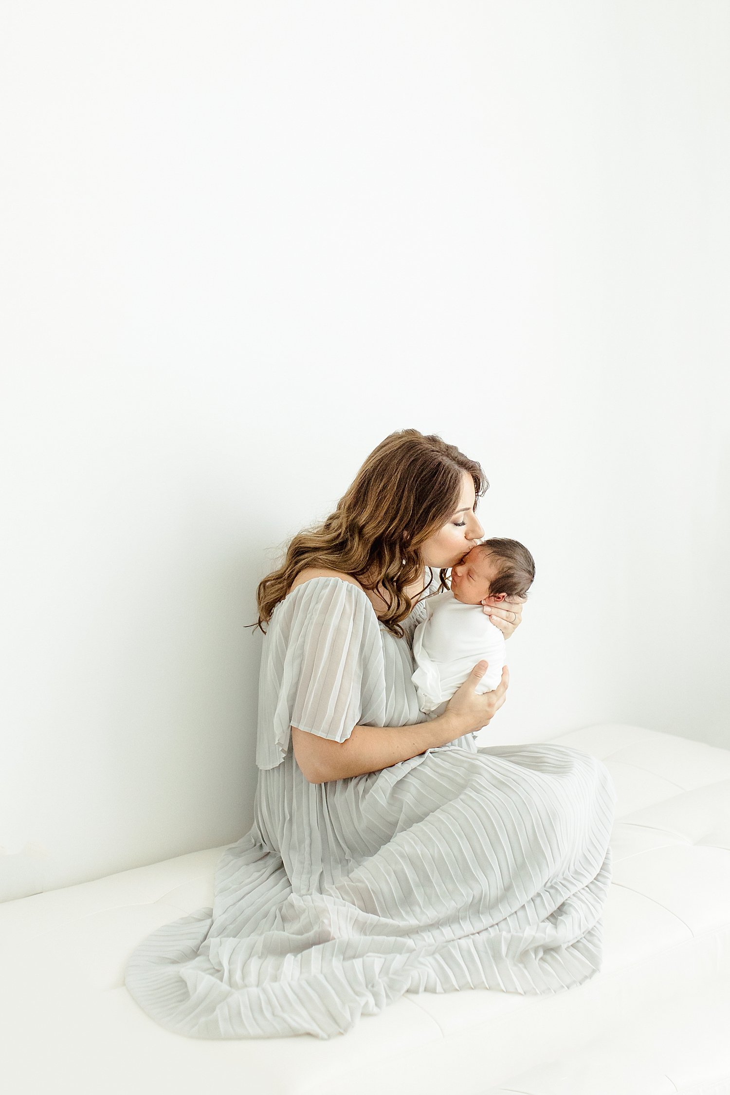 Mom holding her third baby boy during newborn session | Kristin Wood Photography