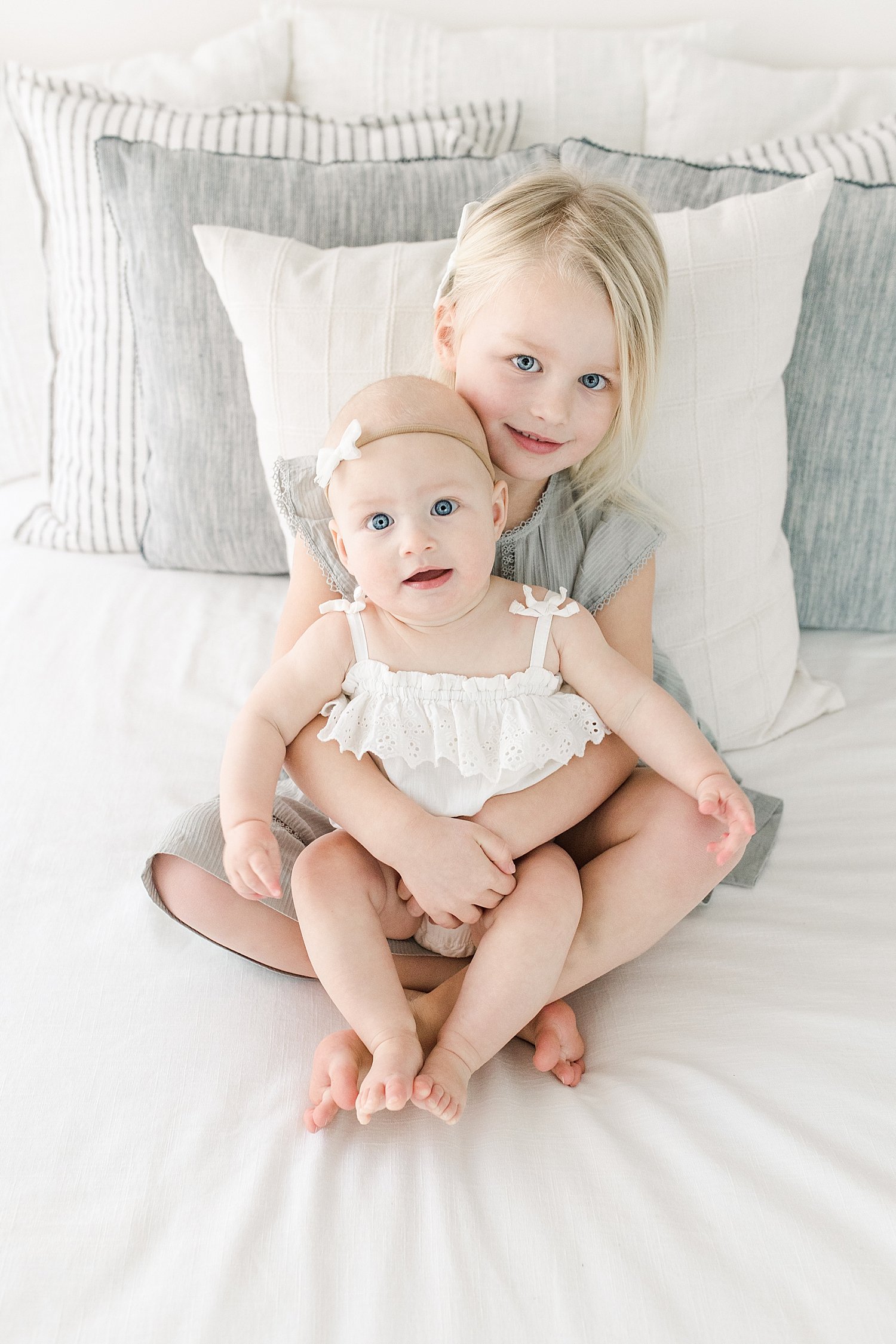 Big sister holding her baby sister | Kristin Wood Photography