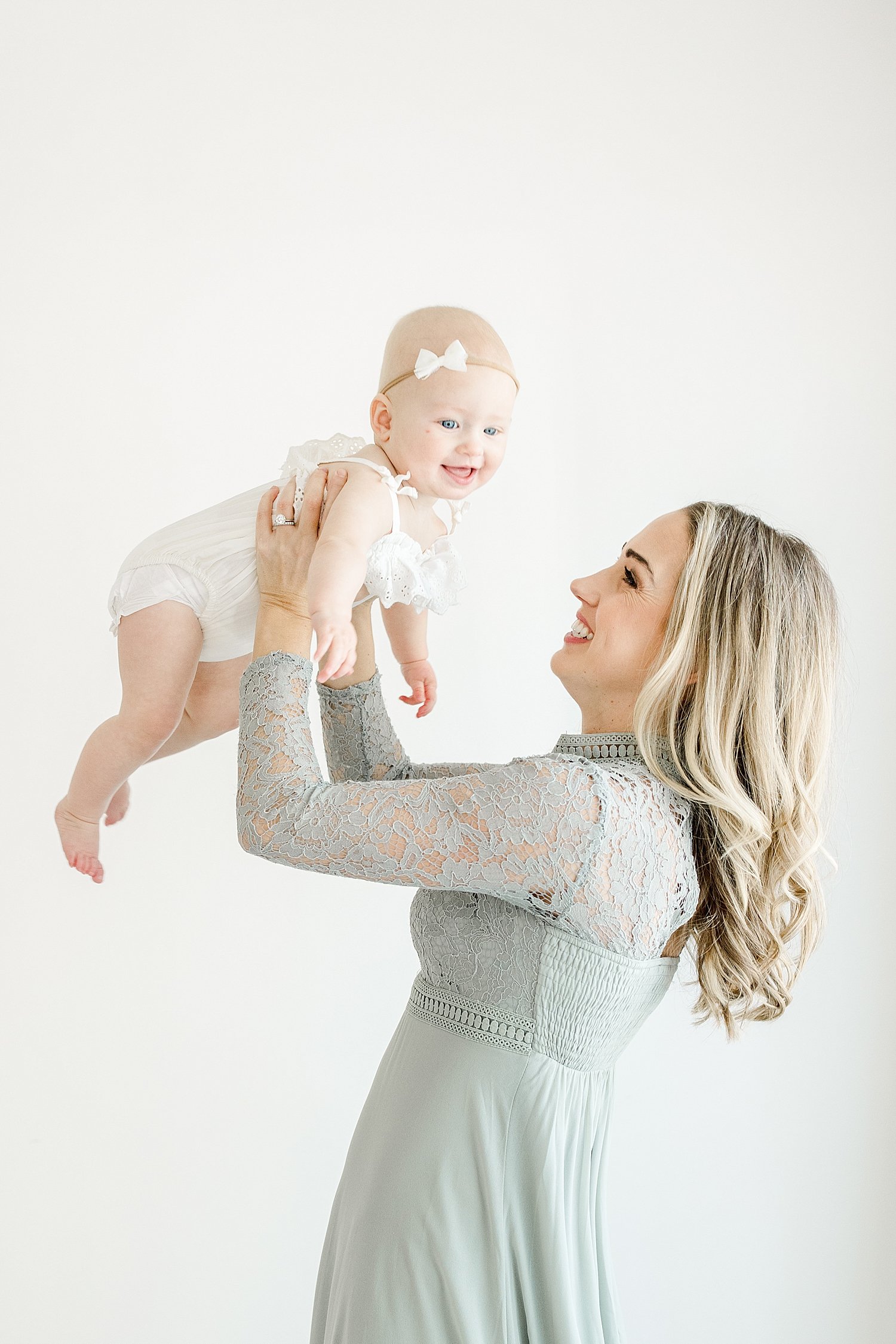 Mom holding baby girl up in the air | Kristin Wood Photography