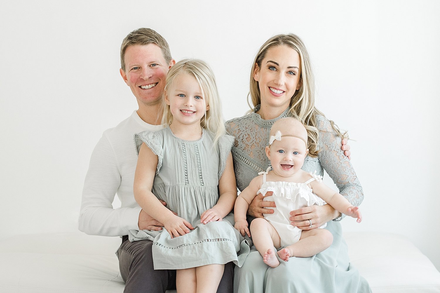 Parents with their two girls during family photoshoot in studio in Westport with Kristin Wood Photography.