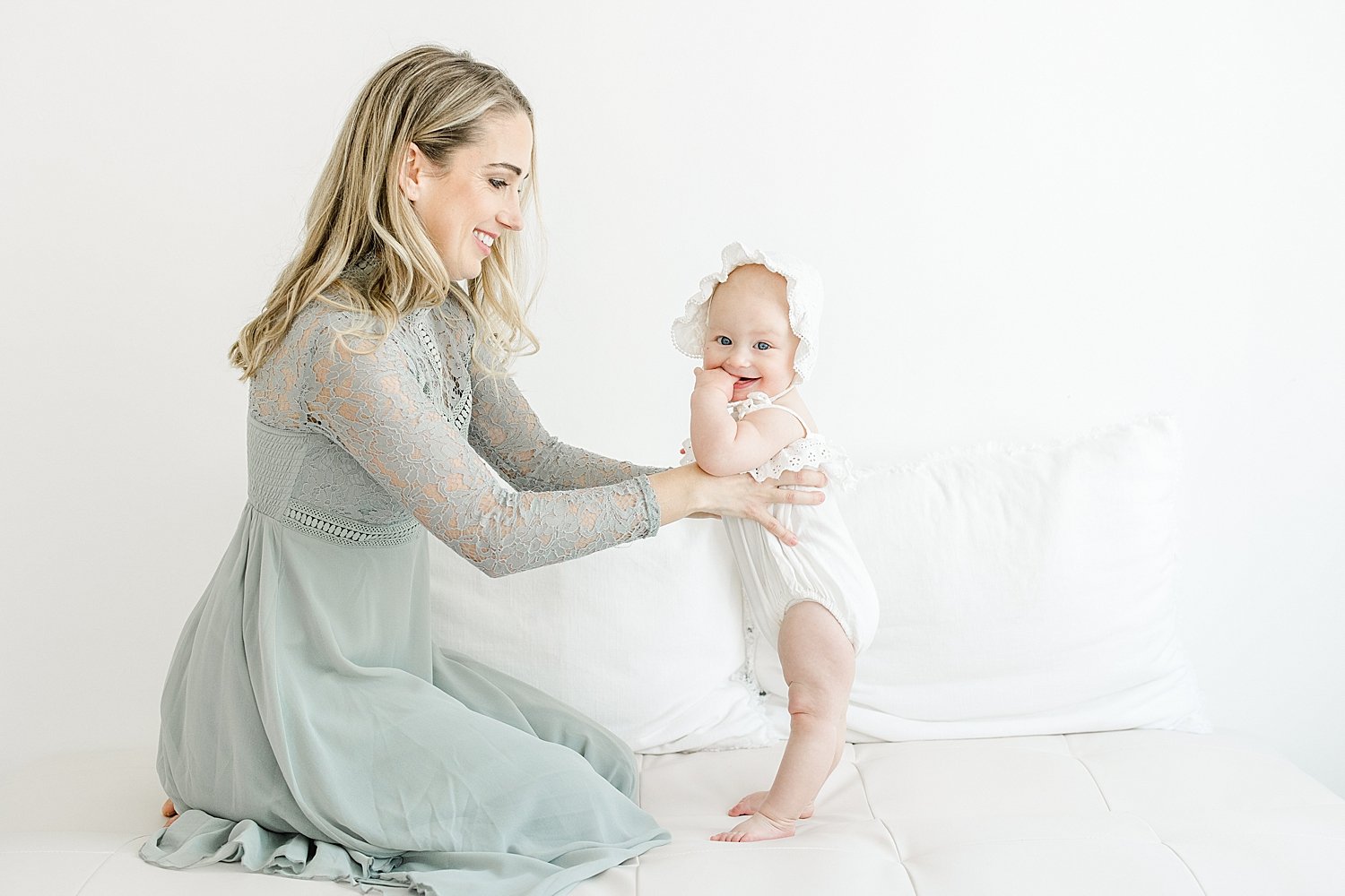 Baby girl standing in front of her Mom | Kristin Wood Photography