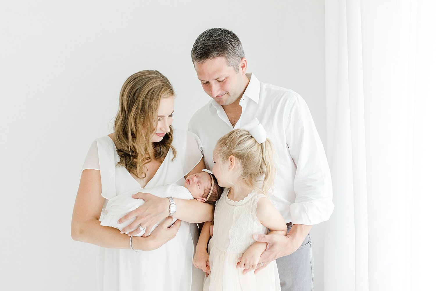 Family of four in studio for newborn session | Kristin Wood Photography