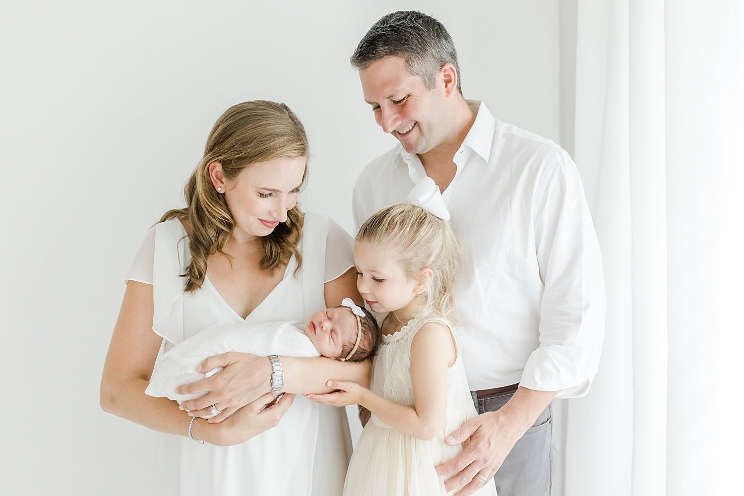 Family of four in studio for newborn session | Kristin Wood Photography