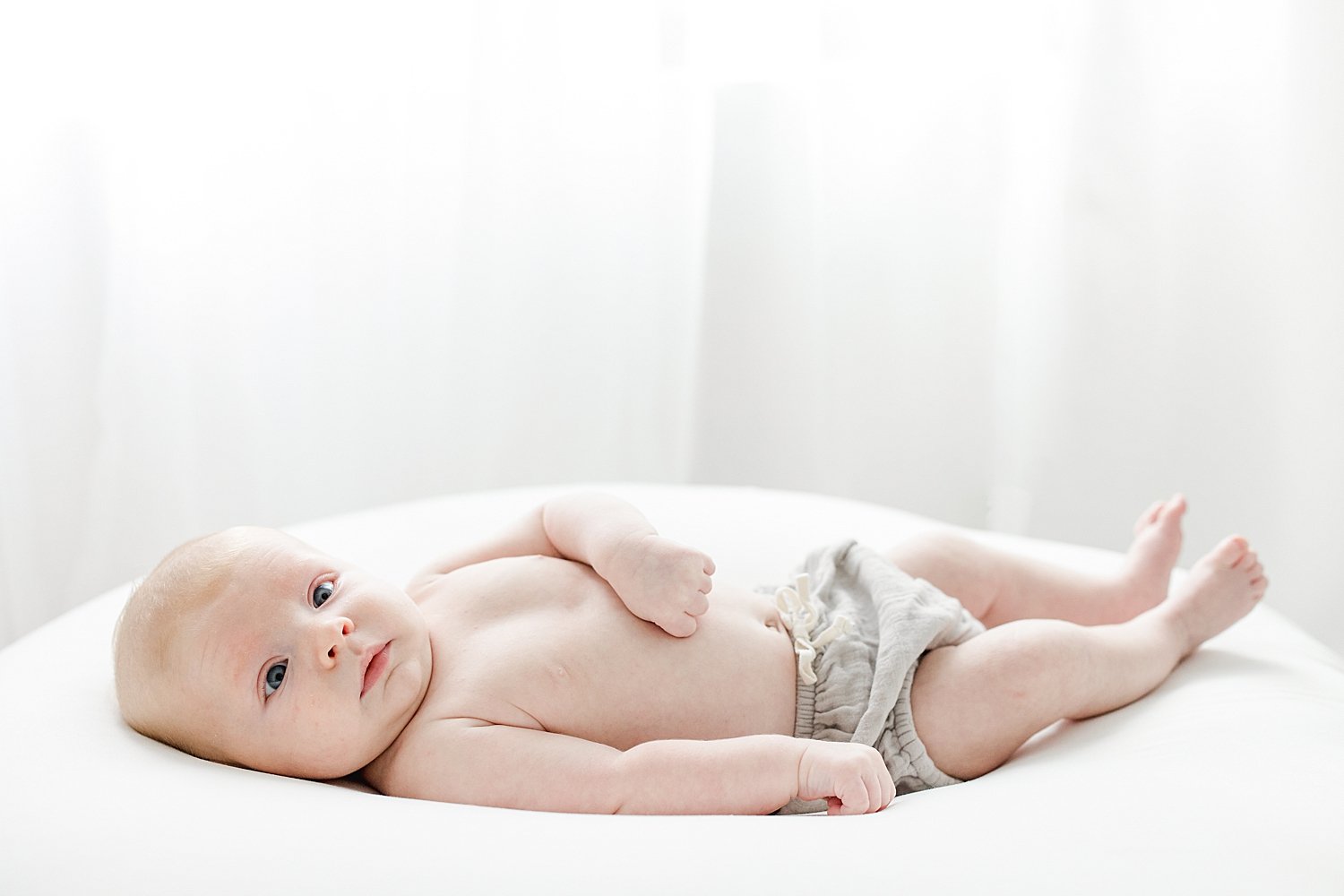 Eight week old newborn wide awake for photoshoot in studio with Kristin Wood Photography.