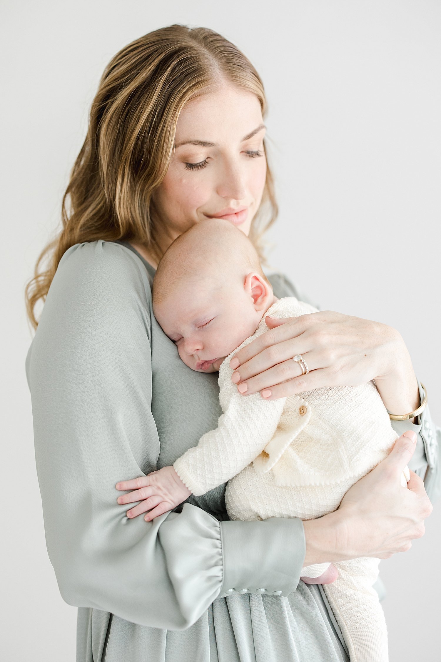 Mom holding newborn son for photos with Kristin Wood Photography.