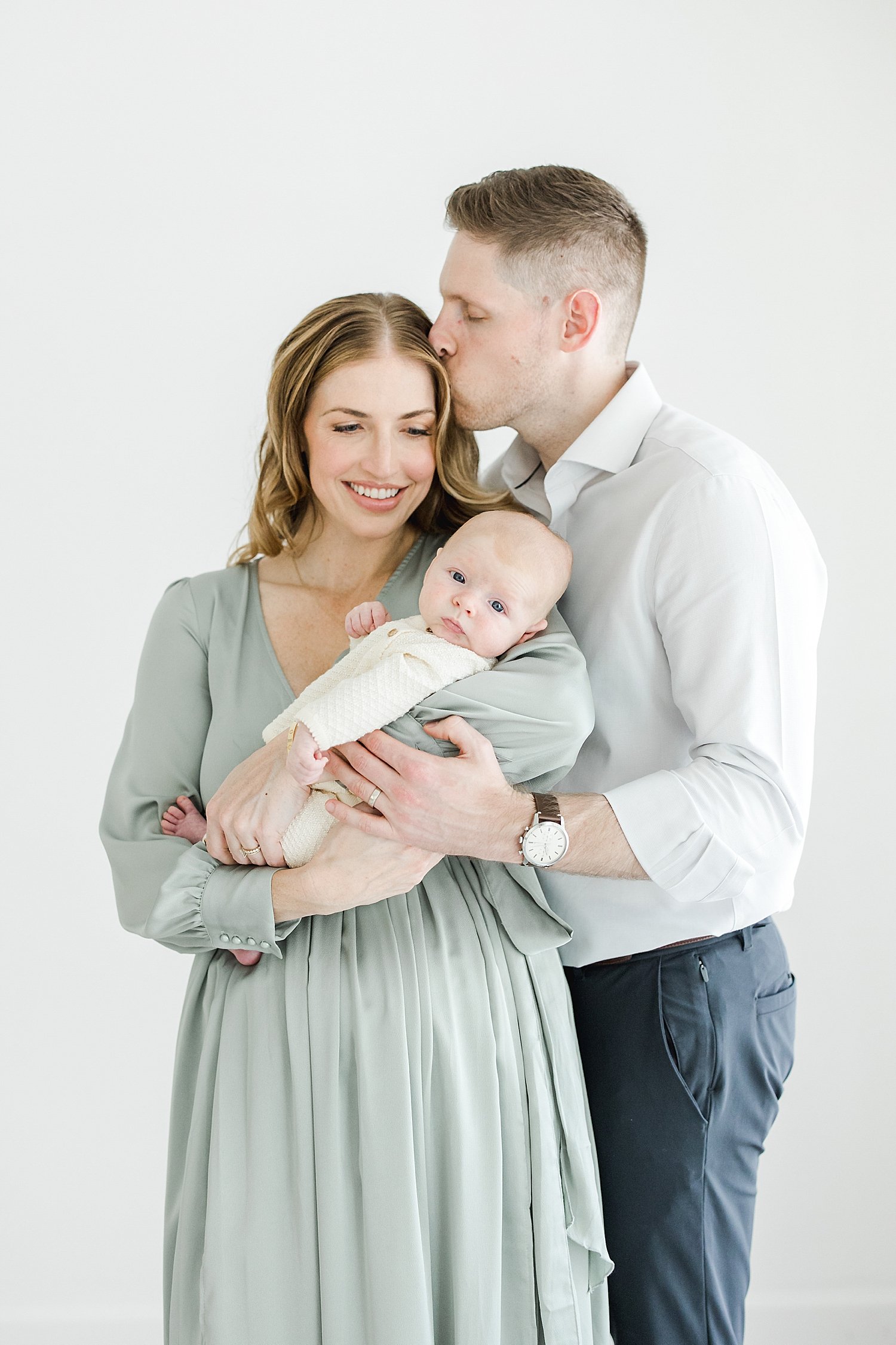 Parents holding their eight week old baby boy for newborn photos with Kristin Wood Photography in Fairfield County, CT.