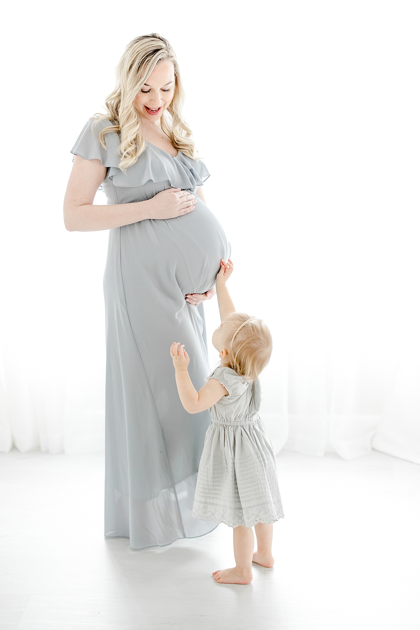 5 Reasons Why You Should Take Maternity Photos | Toddler reaching up and touching moms pregnant belly | Kristin Wood Photography