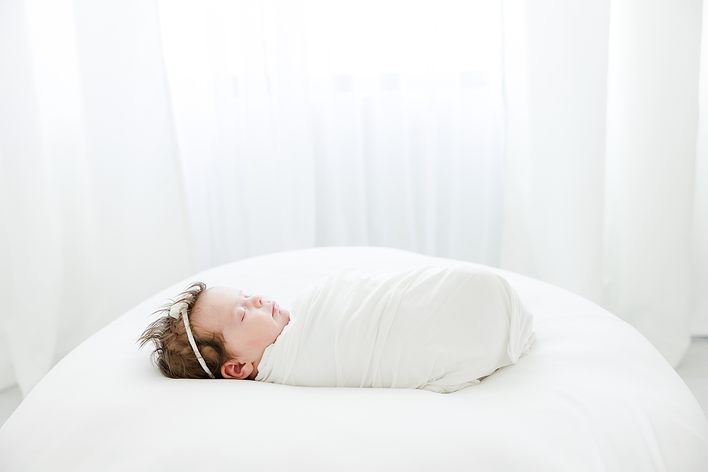 newborn baby girl swaddled and sleeping | Kristin Wood Photography