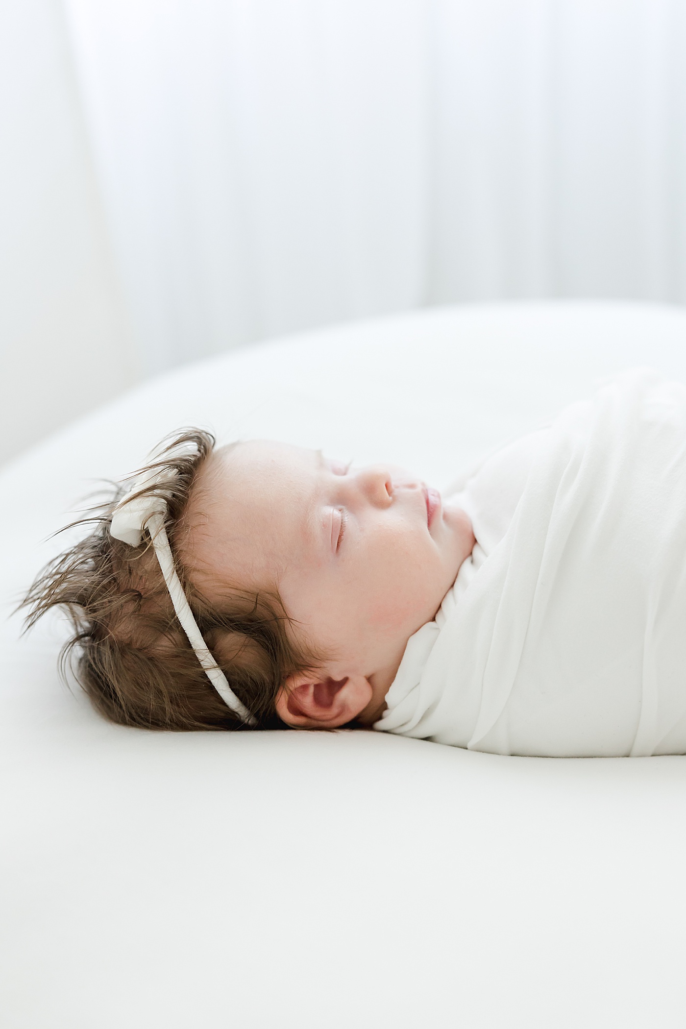 newborn baby girl swaddled and sleeping | Kristin Wood Photography