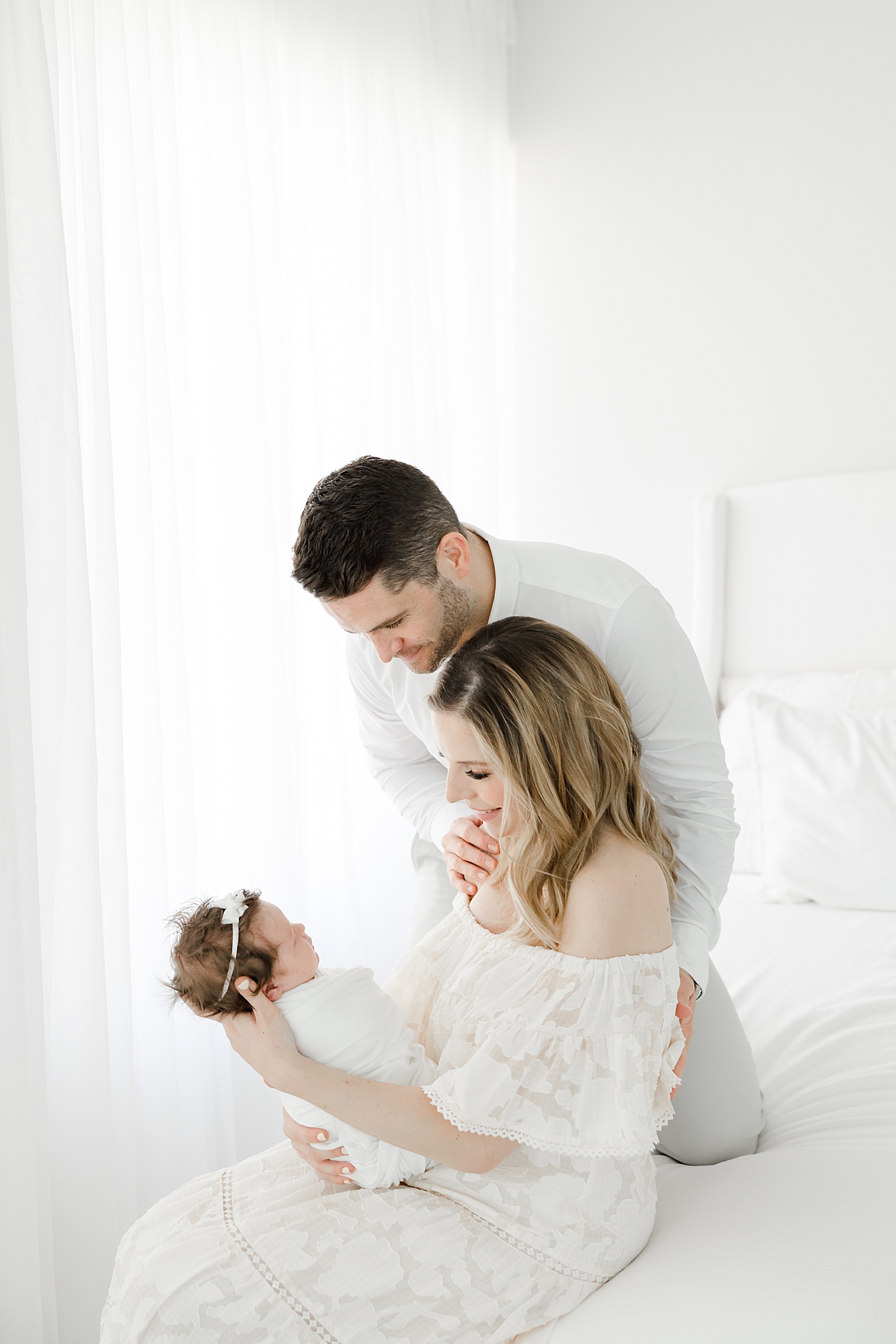 Mom and Dad looking at their newborn daughter | Kristin Wood Photography