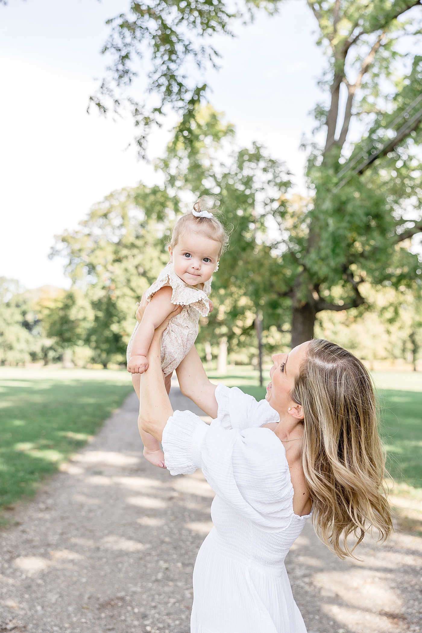 Mom holding baby girl up in the air | Kristin Wood Photography