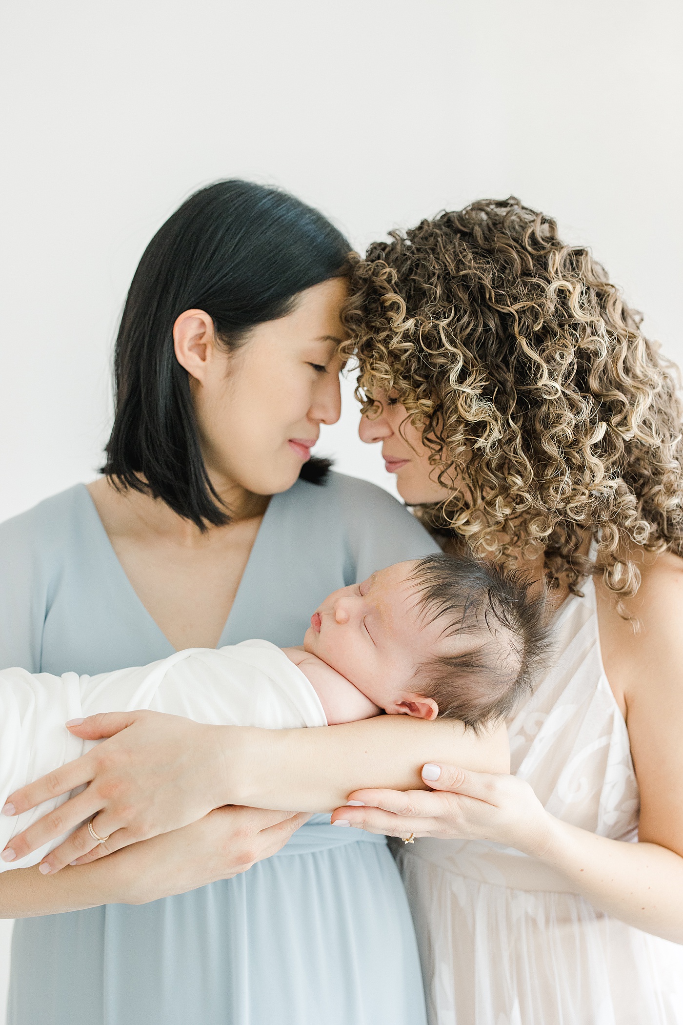 Moms holding their newborn son | Kristin Wood Photography