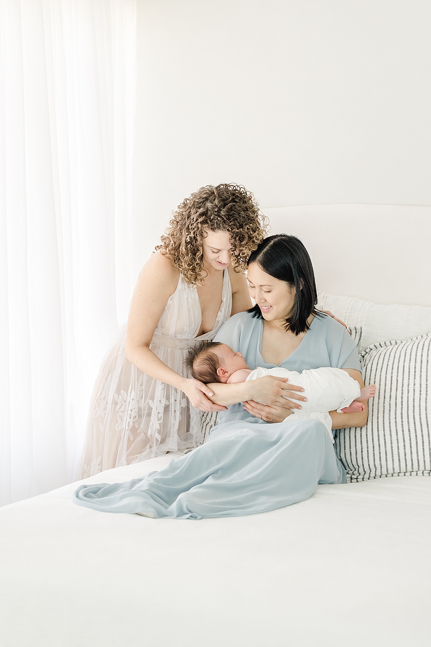 Moms holding their newborn son | Kristin Wood Photography