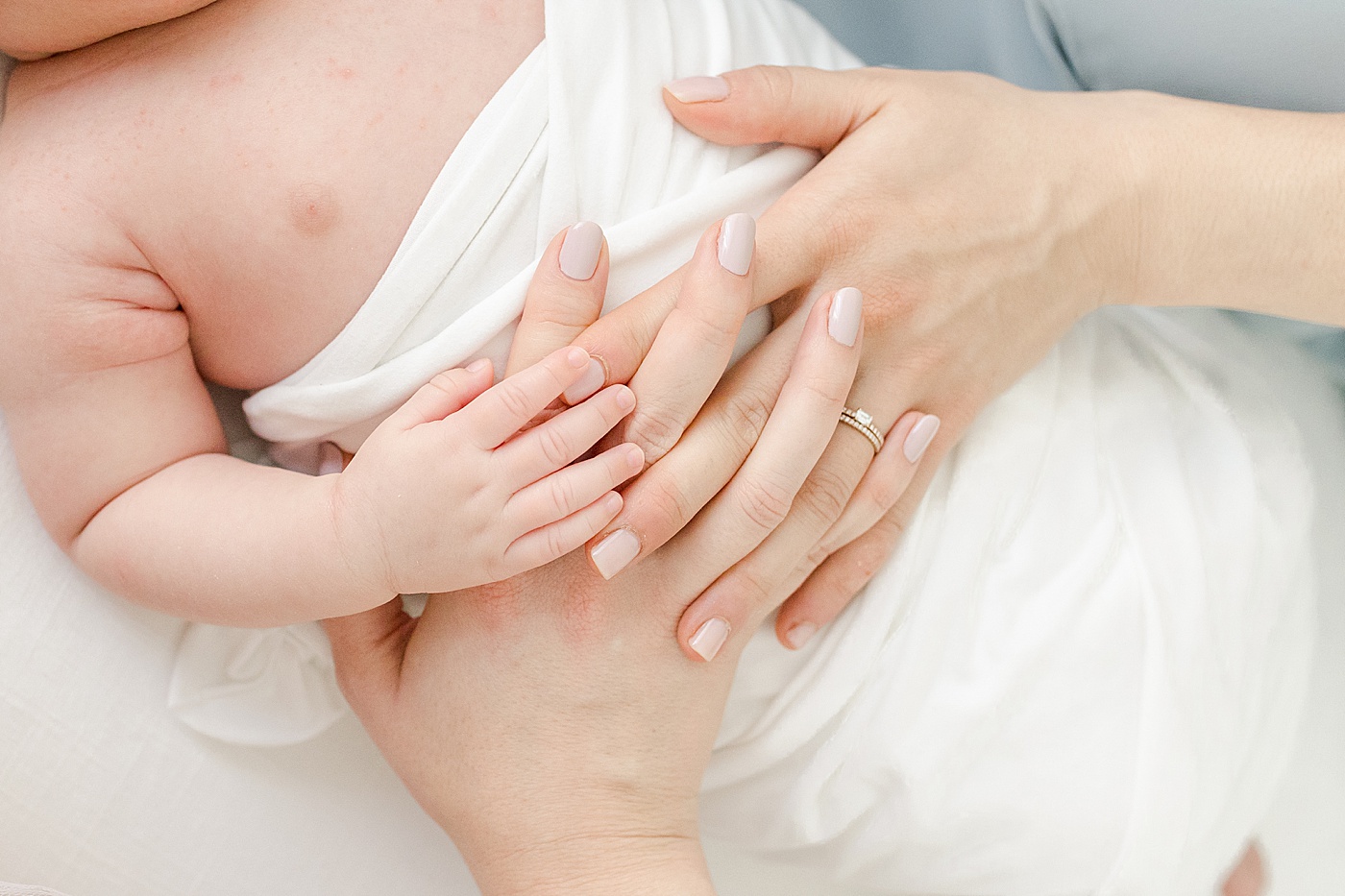 Moms with their hands on newborn baby | Kristin Wood Photography
