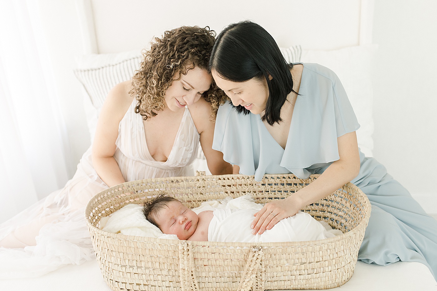 Moms with newborn son in Moses basket | Kristin Wood Photography