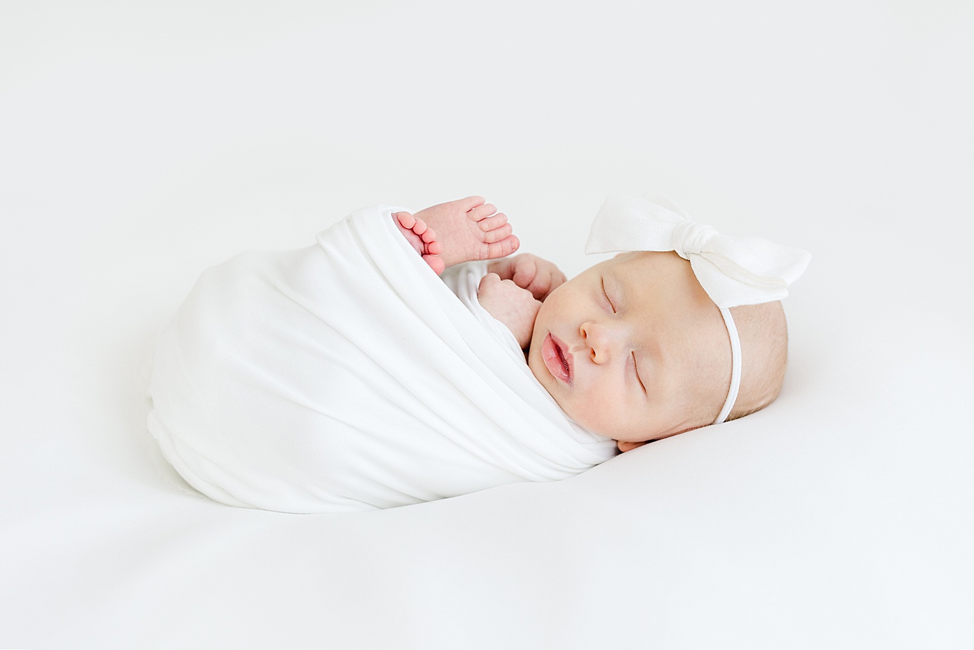 Baby girl swaddled for newborn photos with Kristin Wood Photography.