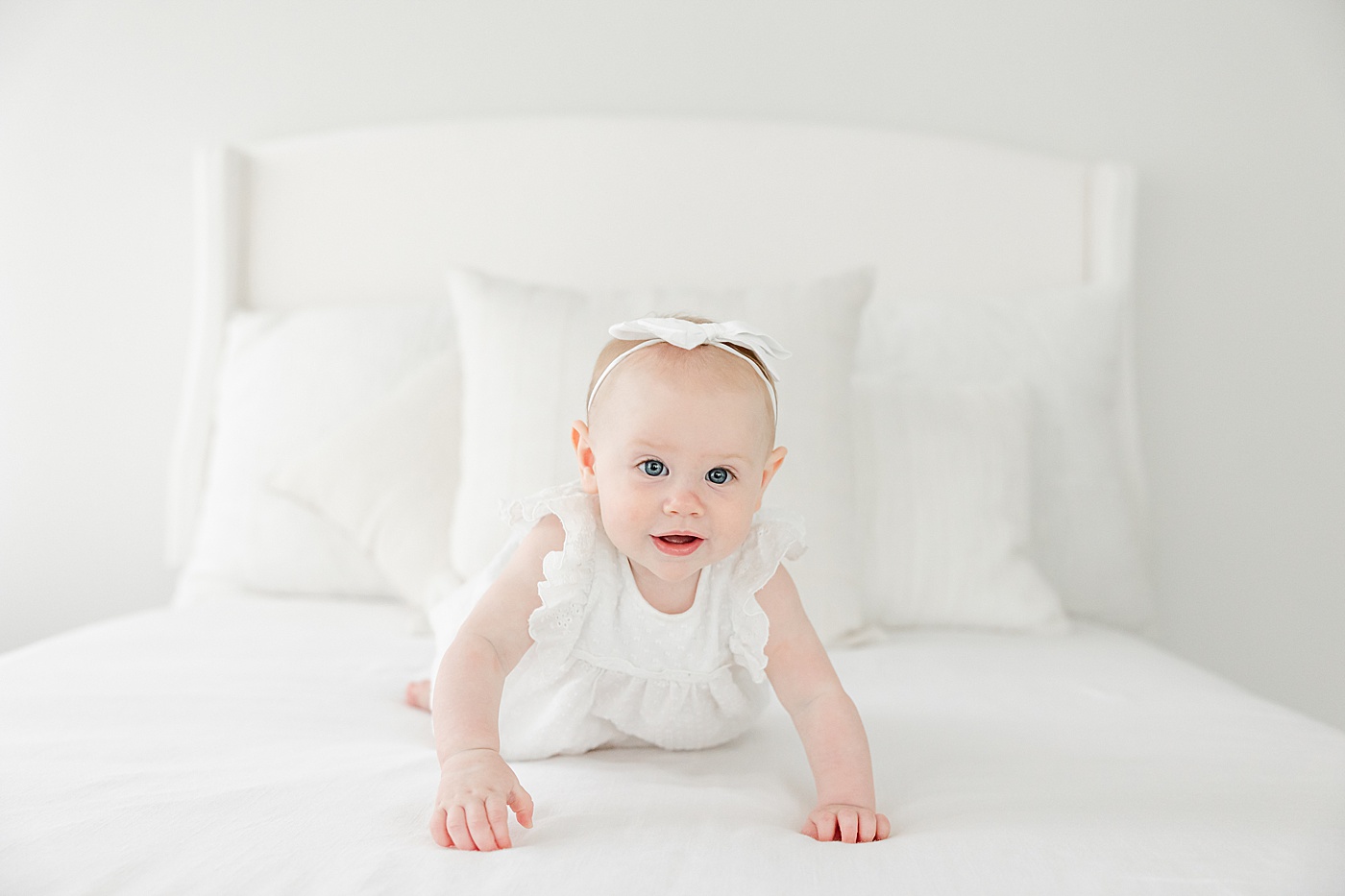 7 month old baby girl crawling on bed | Kristin Wood Photography
