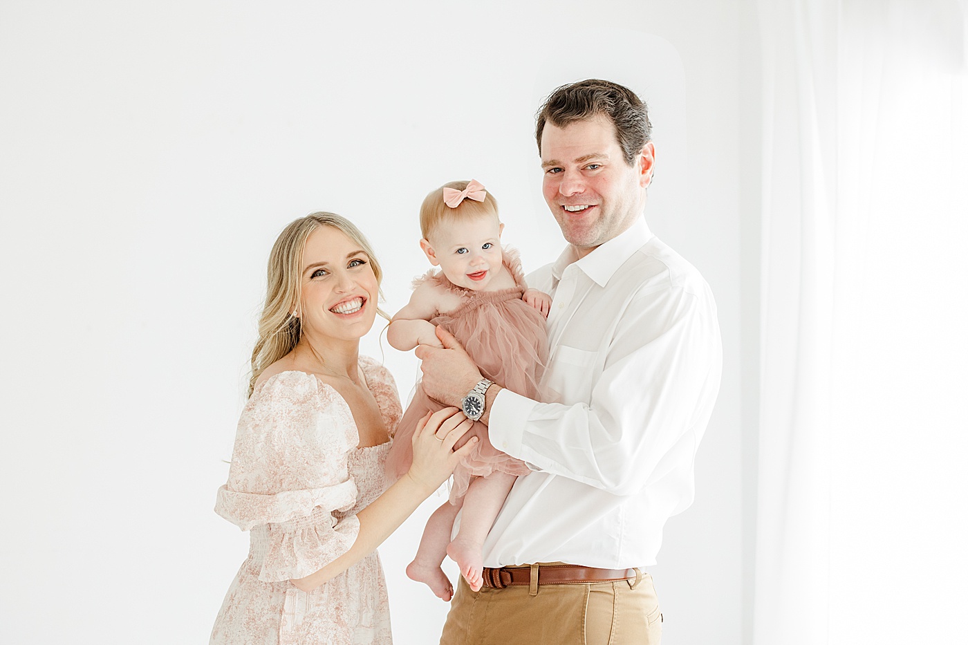 Mom and Dad with daughter during first birthday photoshoot with Kristin Wood Photography.