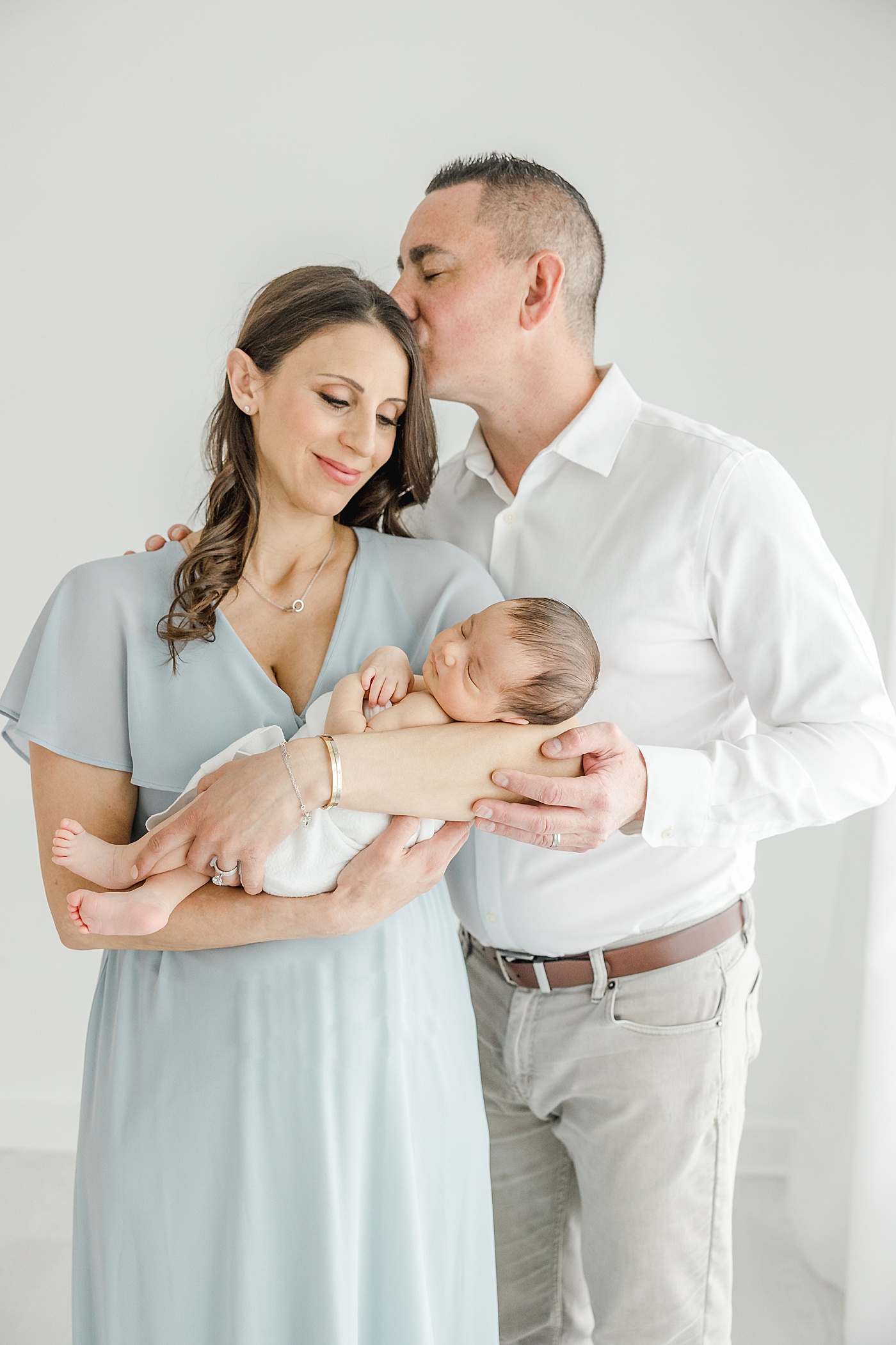 Mom and Dad with their newborn son during photos with Kristin Wood Photography.