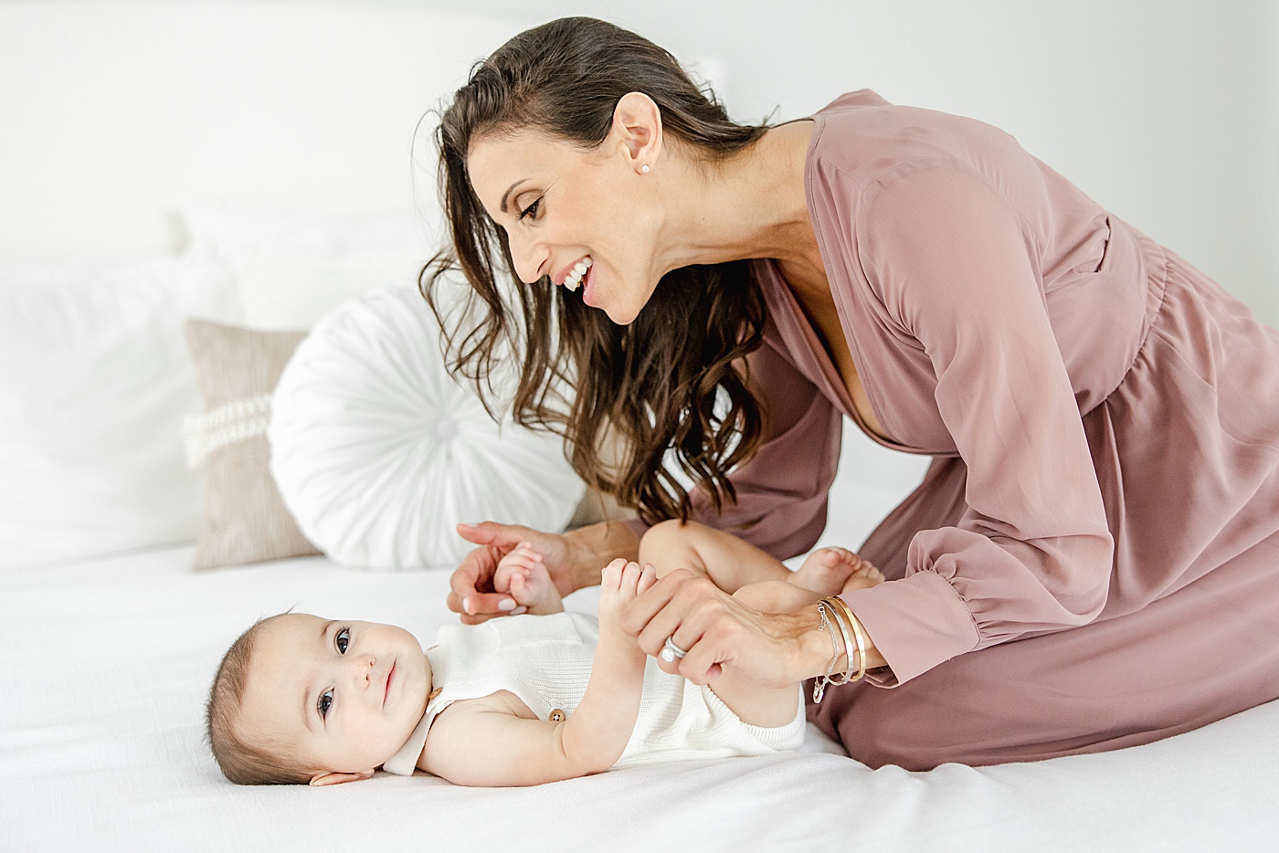 Mom playing with son on bed | Kristin Wood Photography