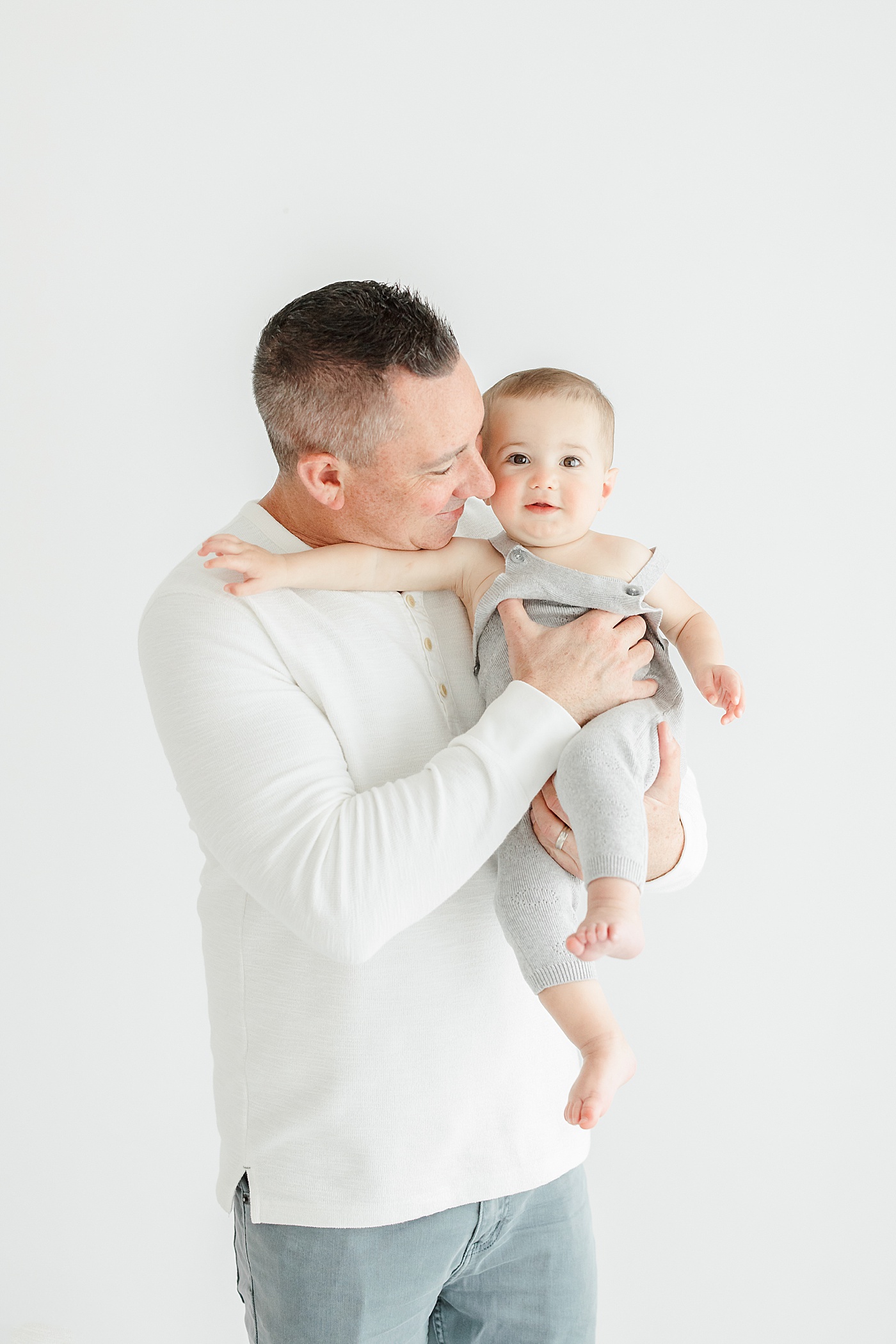 Father-son photos during first birthday photoshoot in studio with Kristin Wood Photography.