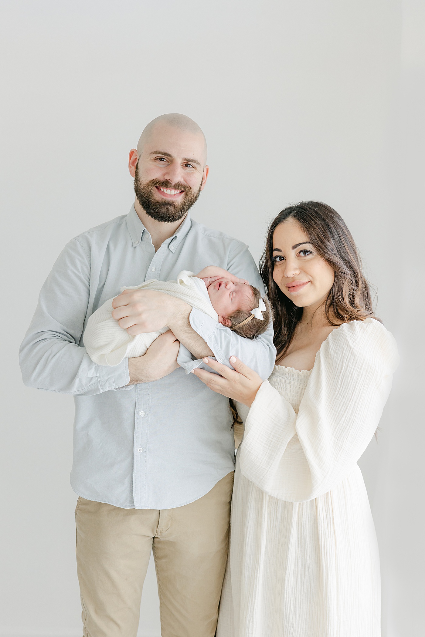First-time parents with baby girl during newborn photos with Kristin Wood Photography.