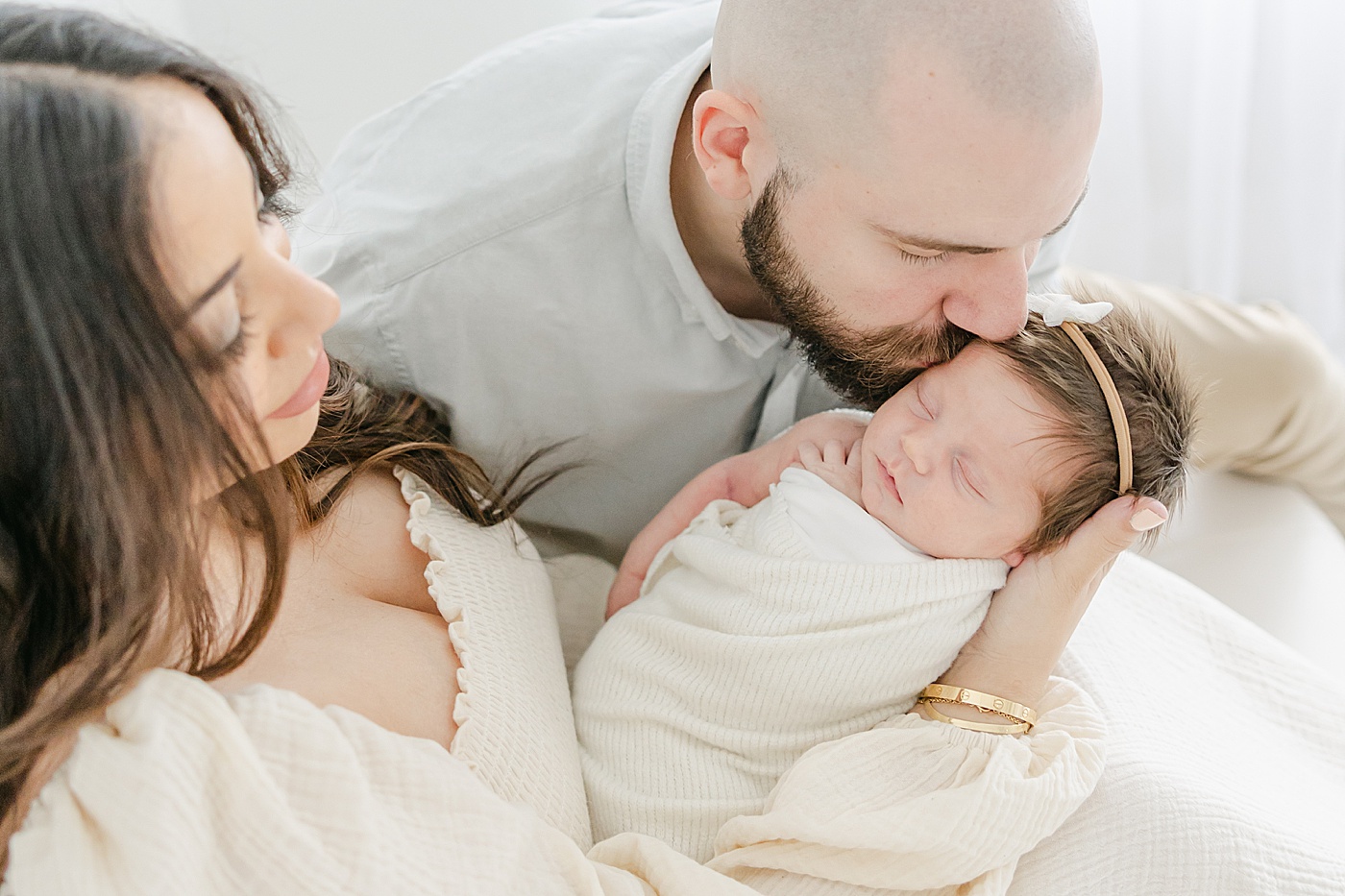 Dad giving newborn daughter a kiss | Kristin Wood Photography