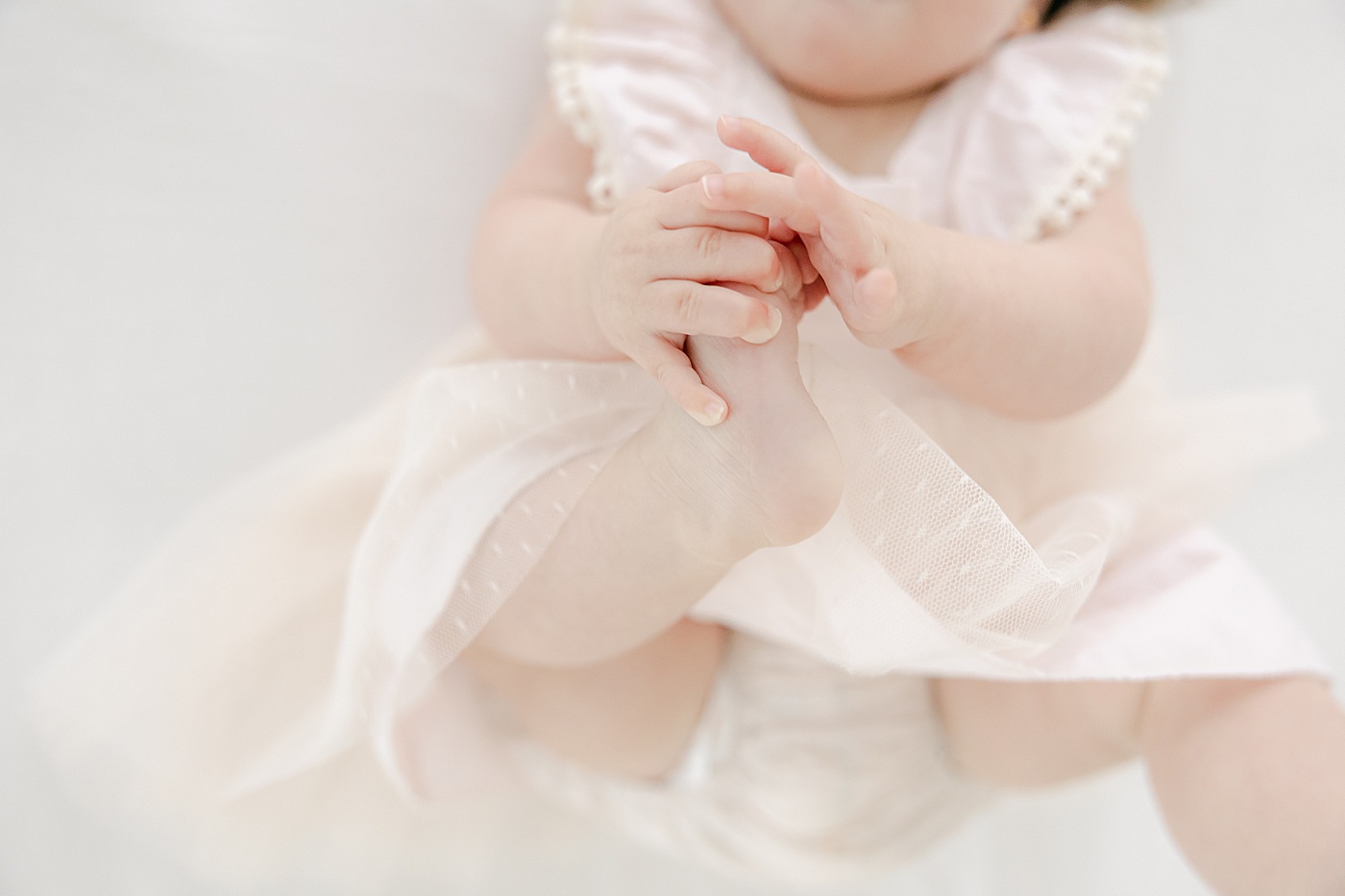 6 month old grabbing her toes | Kristin Wood Photography
