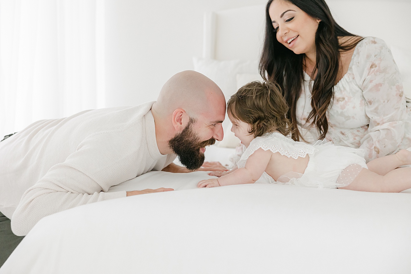 Dad and daughter laughing together during family portraits with Kristin Wood Photography